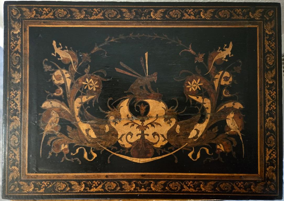PRESENTING an ABSOLUTELY GORGEOUS and EXTREMELY UNIQUE and RARE 19C British Tunbridgeware Micromosaic Lap Desk.

This lap desk is unlike any of it’s kind we have seen before.

From circa 1840 – 60.

Made of ebony with gorgeous marquetry inlay on all