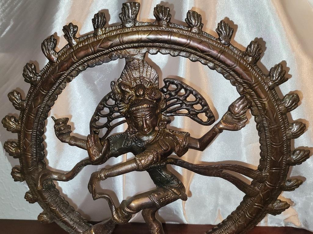 Presenting a GORGEOUS bronze dancing Shiva Nataraja.

We are of the opinion that this is an early to mid 20th century piece. It has a zinc bronze finish/patina which we would not expect with a much older piece.

We are 