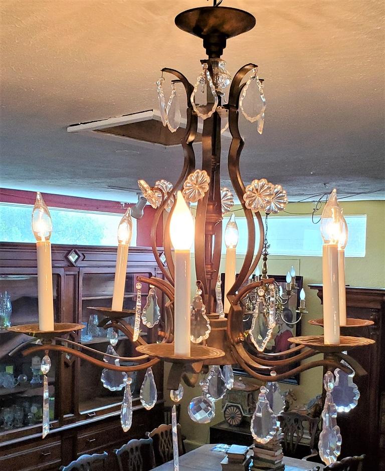 Presenting a lovely 19C French iron and crystal chandelier.

Made circa 1880/90 in France…. the Belle Epoque Era.

Made of iron with turned and fluted central column. Bulbous central arms. Bell shaped base with 6 arms/branches with parquay