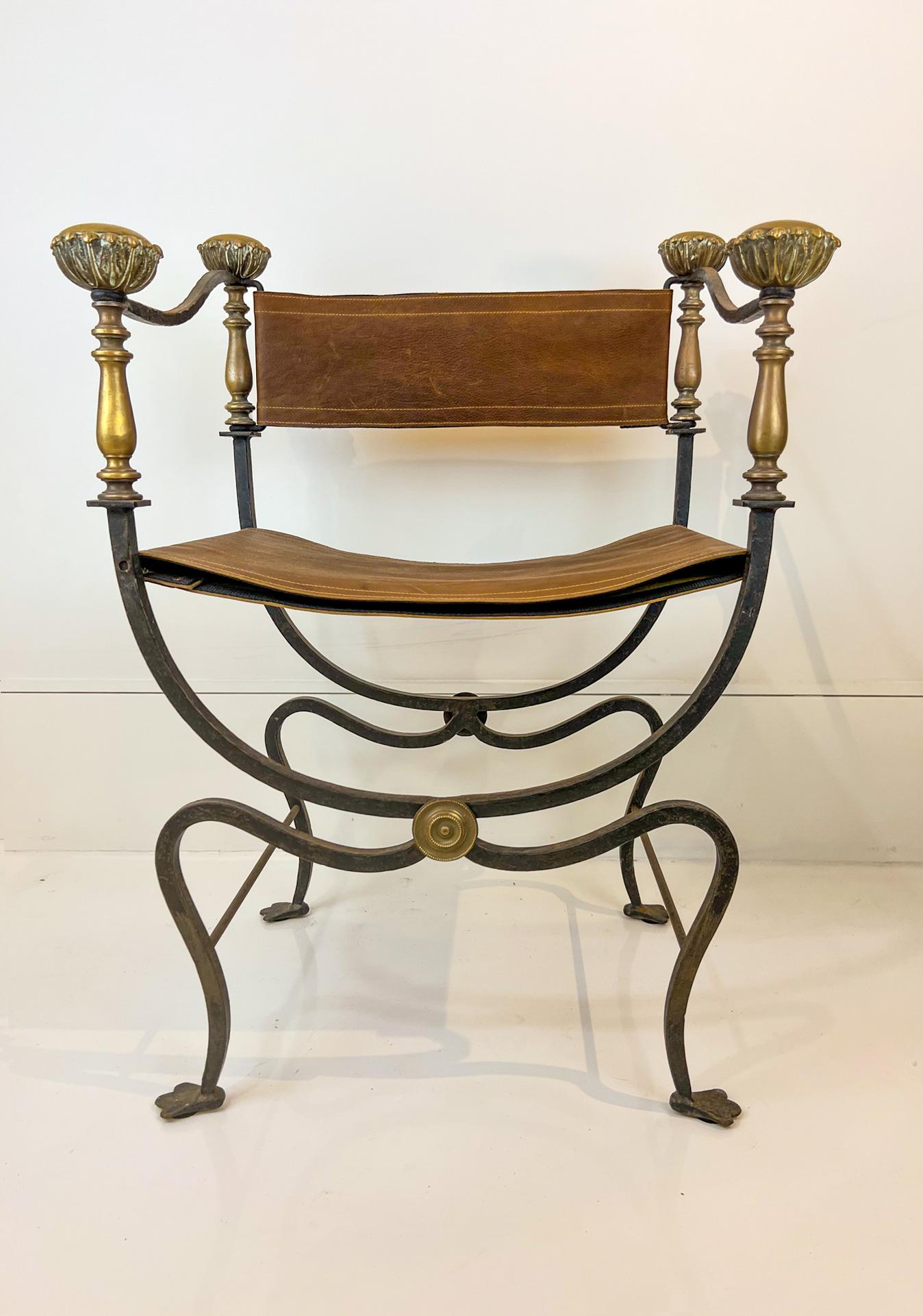 This very popular type of chair is perfect for a pull up or at a desk. The appeal is it's geometry: Arched legs and rectangular seat and back with a flourish of brass knobs on the arms.