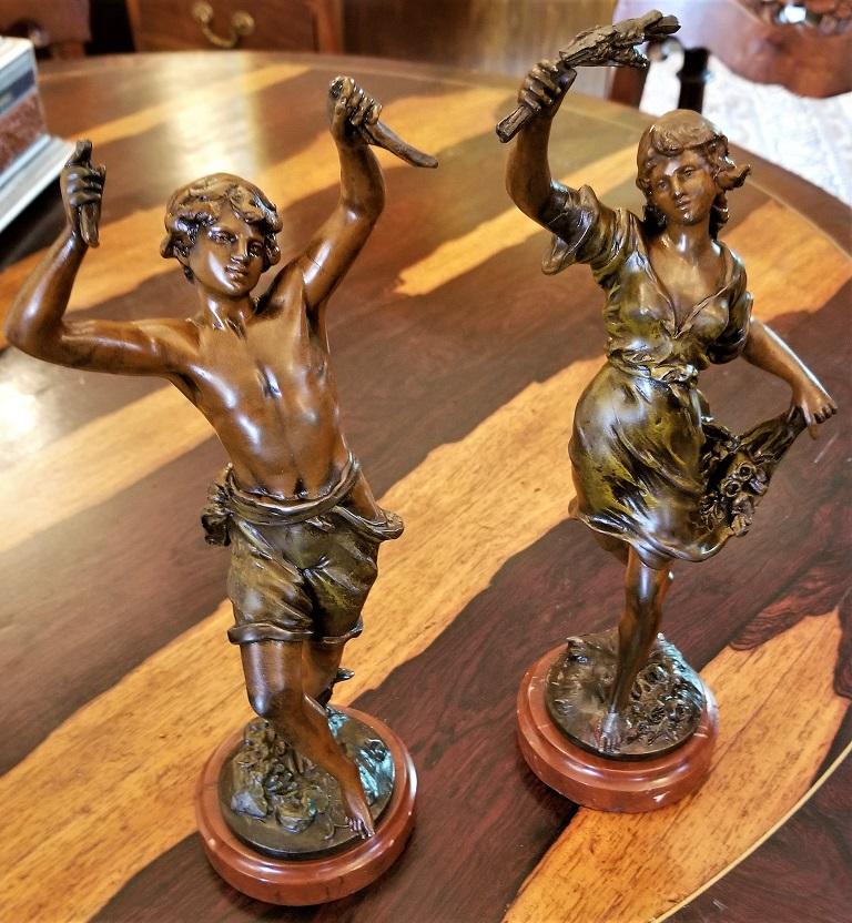 Presenting a lovely 19th century pair of bronzed spelter sculptures after Auguste Moreau.

Made circa 1890 in Paris, France.

Foundry mark stamp for Fabrication Francais, Paris, Made in France.

Polychromed finish and each sits on a red marble