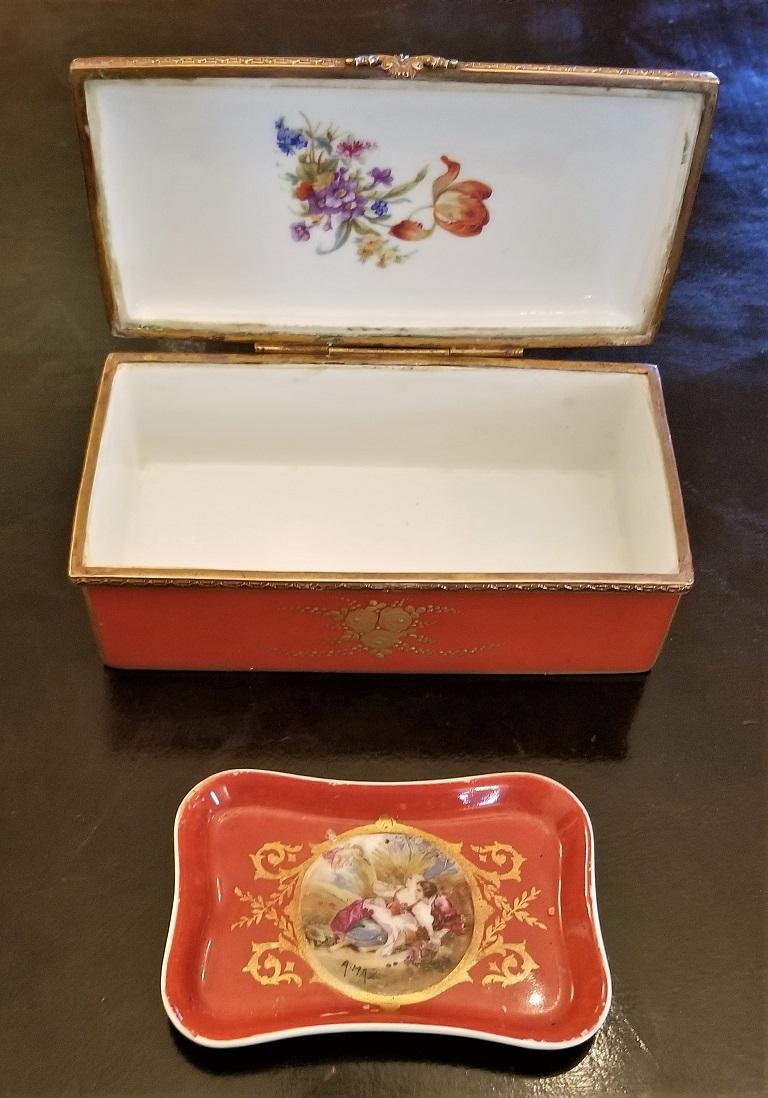 Presenting a gorgeous and rare matching pair, namely, a 19th century Sevres Porcelain trinket box with ring tray.

The trinket box os a very good size and has gilt edging and overlay throughout.

The central hand painted medallion on the lid is