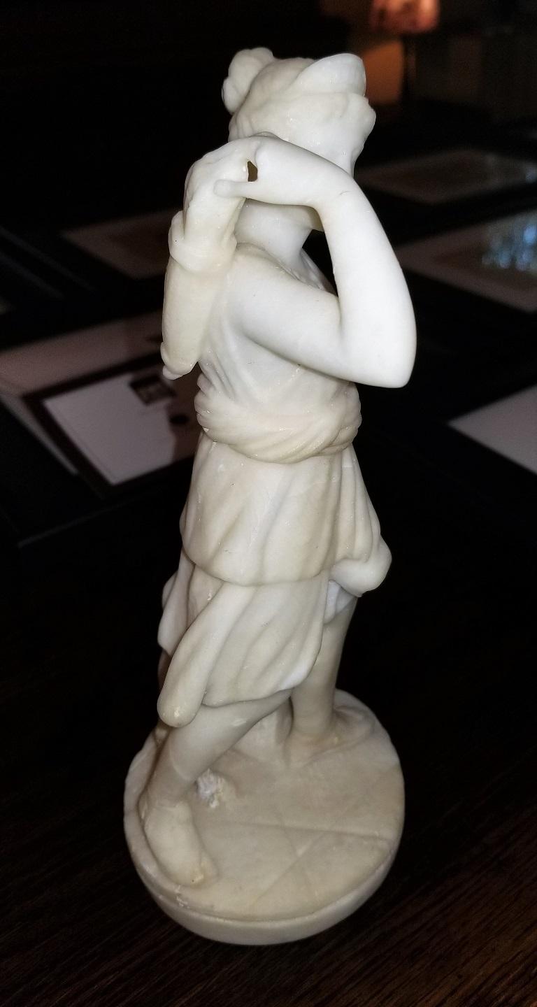 Presenting a lovely 19th century white marble Statue of Siana.

A keepsake from the Grand Tour.

From circa 1840. Probably Italian. Unmarked.

It depicts the Goddess ‘Diana’ with a lamb or goat and arrow quiver on her back. Dressed in a