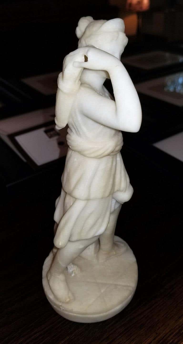 Presenting a lovely 19th century white marble Statue of Siana.
A keepsake from the Grand Tour.
From circa 1840. Probably Italian. Unmarked.
It depicts the Goddess ‘Diana’ with a lamb or goat and arrow quiver on her back. Dressed in a