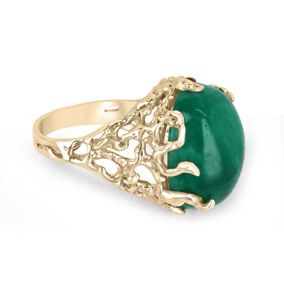 This impressive solitaire ring features a stunning centerpiece in the form of a huge 19-carat oval cabochon cut emerald from Colombia, prized for producing some of the world's most beautiful emeralds. The emerald displays a rich, dark green color