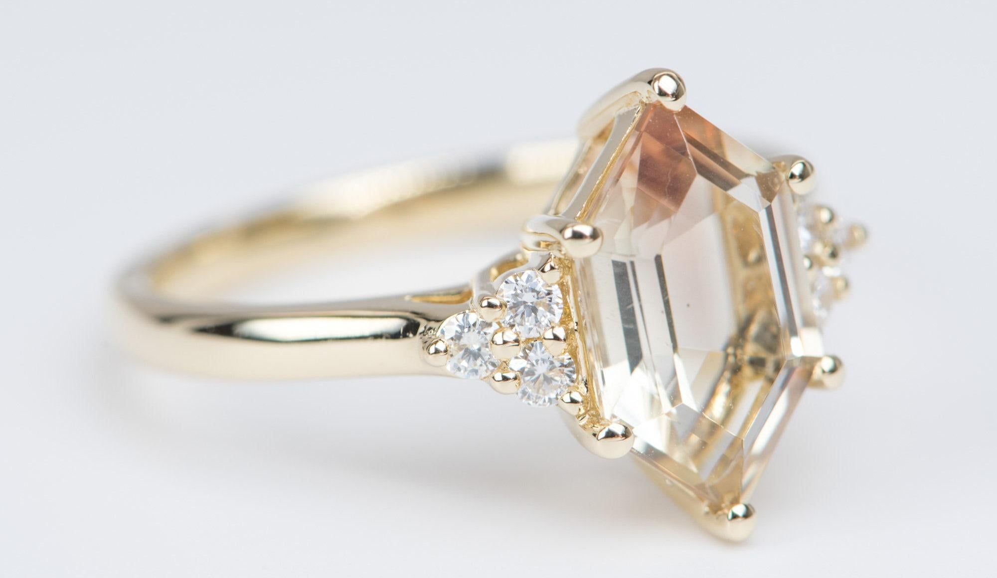 â™¥ Solid 14K yellow gold set with a hexagon shaped Oregon Sunstone in the center with a trio of diamonds on each side
â™¥ The overall setting measures 14.2mm wide, 13.3mm in length, and sits 6mm tall from the finger


â™¥ Ring size: US Size 7 (Free
