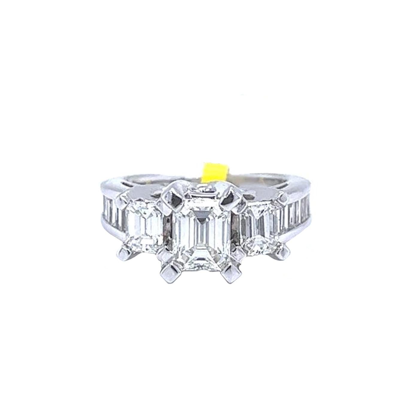 14 Karat White Gold Emerald and baguette Natural diamond ring featuring a Center emerald cut diamond weighing 0.75 carats. The emerald is accented by 0.25 Carat Side diamonds and 0.65 Carat baguette Diamonds. The ring fits a size 6 finger. Its total