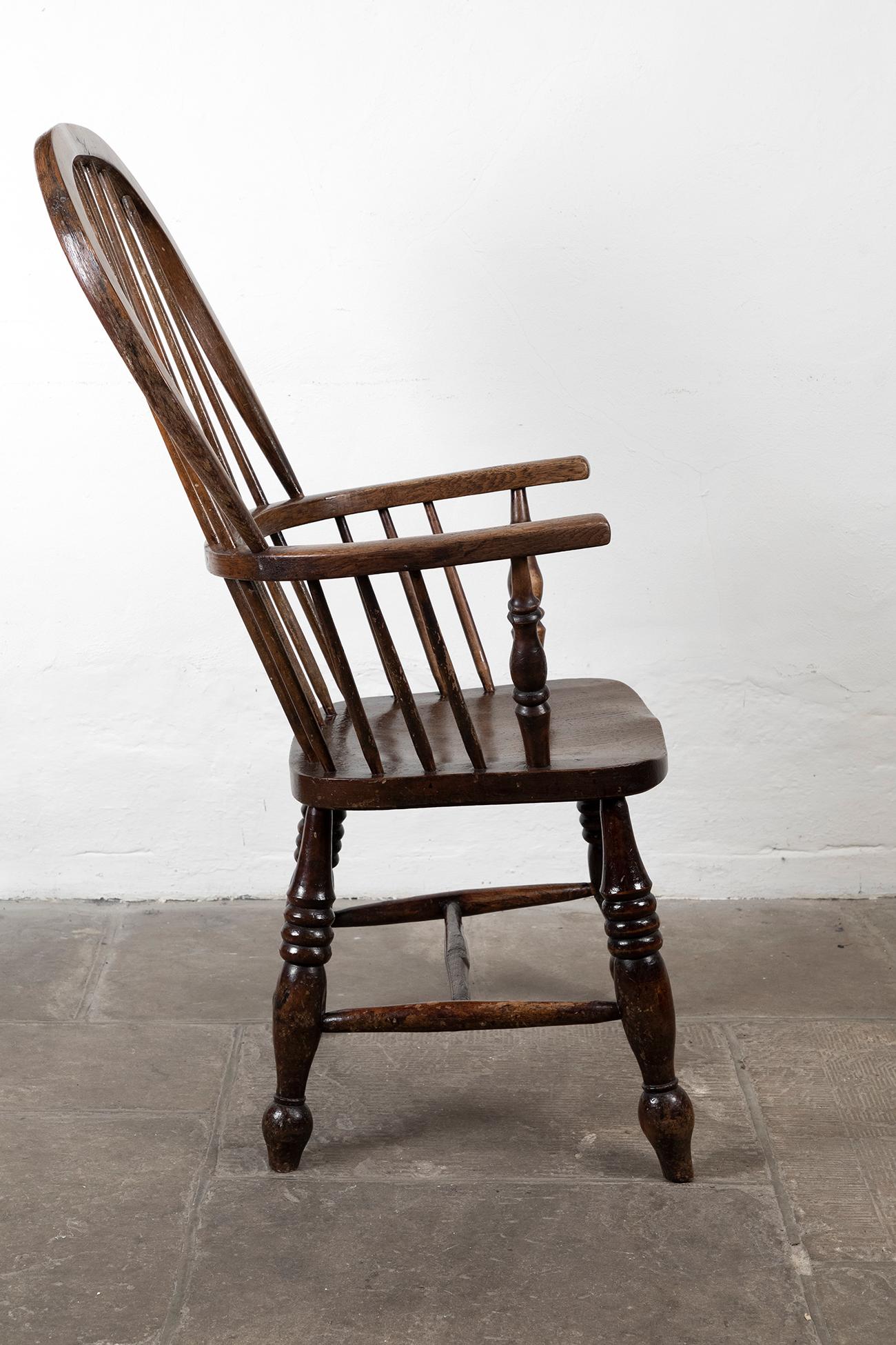 Wonderful 19th century British Windsor hoop back armchair in elm and ash. With remnants of original paint on the arms and back rest, a stunning piece.

Circa, 1860

Additional Information:
H 117 cm (H 46 inches)
W 54 cm (W 21.2 inches)
D 41