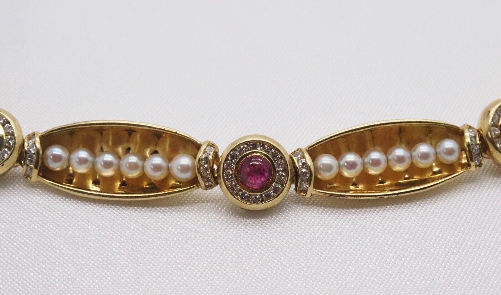 This one of a kind vintage choker is handcrafted in 19k yellow gold. The elongated shell-like links feature a row round natural pearls accented by a row of diamonds on either end and alternate between round links supporting a cabochon ruby in the