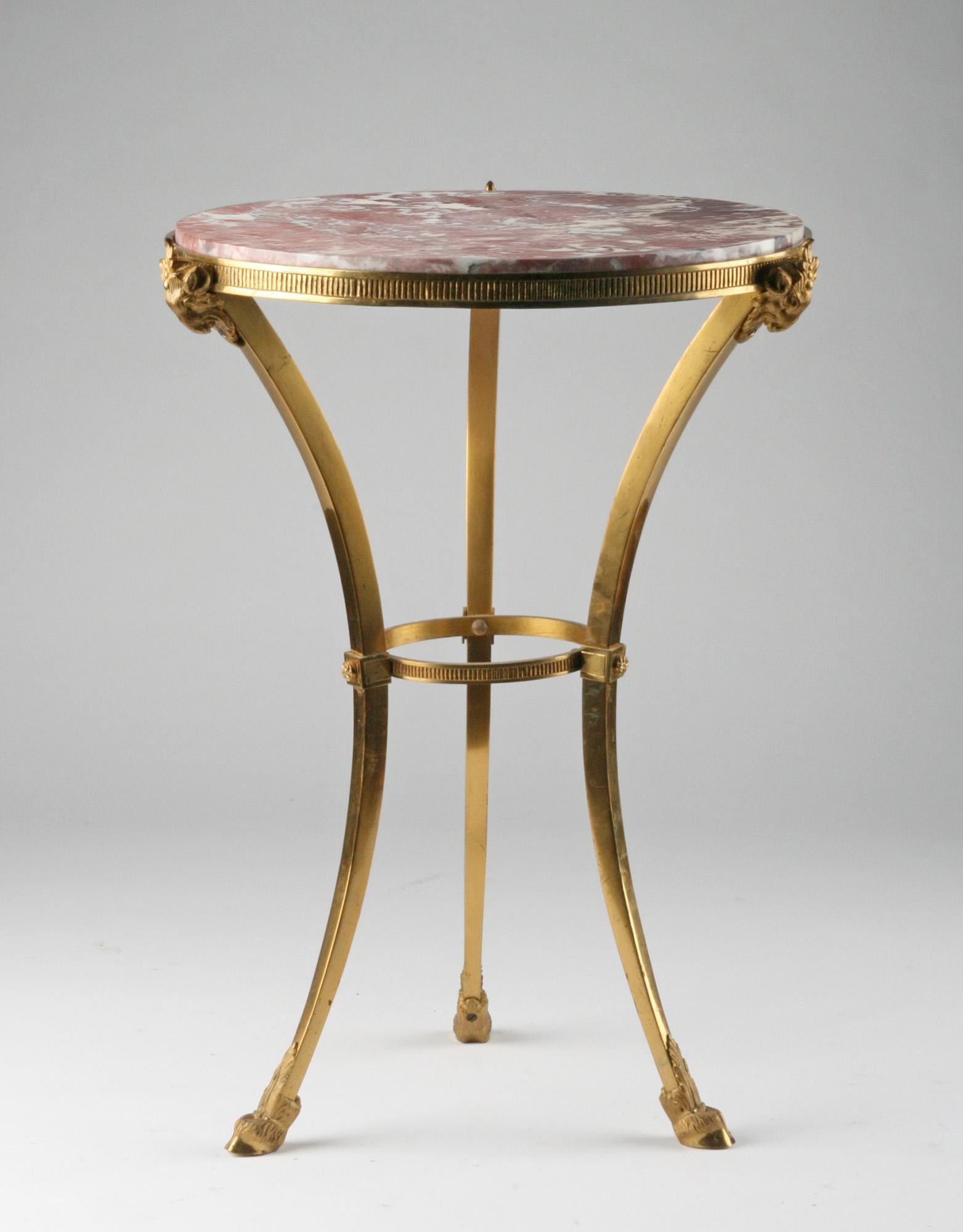 An elegant side table from the French Napoleon III period. The basis is a solid bronze tripod. Embellished with mercury gilded bronze ram's heads and legs. On the top a pink marble top. The pink marble combines beautifully with the bronze.