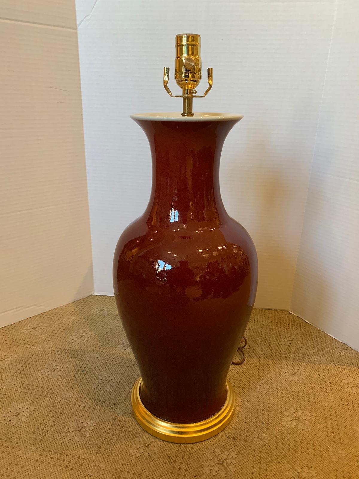 19th-20th century Chinese Sang de Boeuf oxblood porcelain vase as lamp on custom giltwood base.