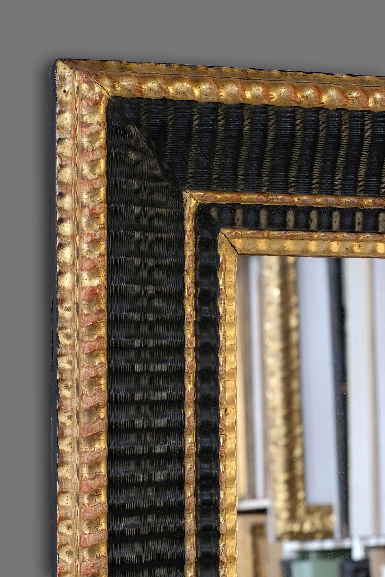 An eye-catching late 19th-early 20th century French Artist's frame. It has a reeded ogee profile with wave moulding and the frame retains its well preserved original parcel gilding and black tempera. Further information on this style of frame