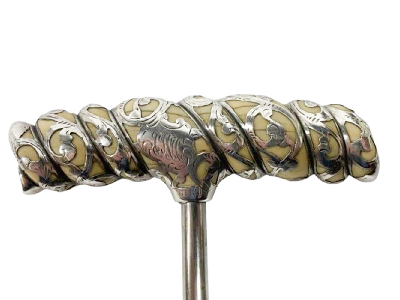 American silver overlaid carved ivory handle c.1900. The rope twist carved ivory handle with sterling silver overlaid scrolling leaves.