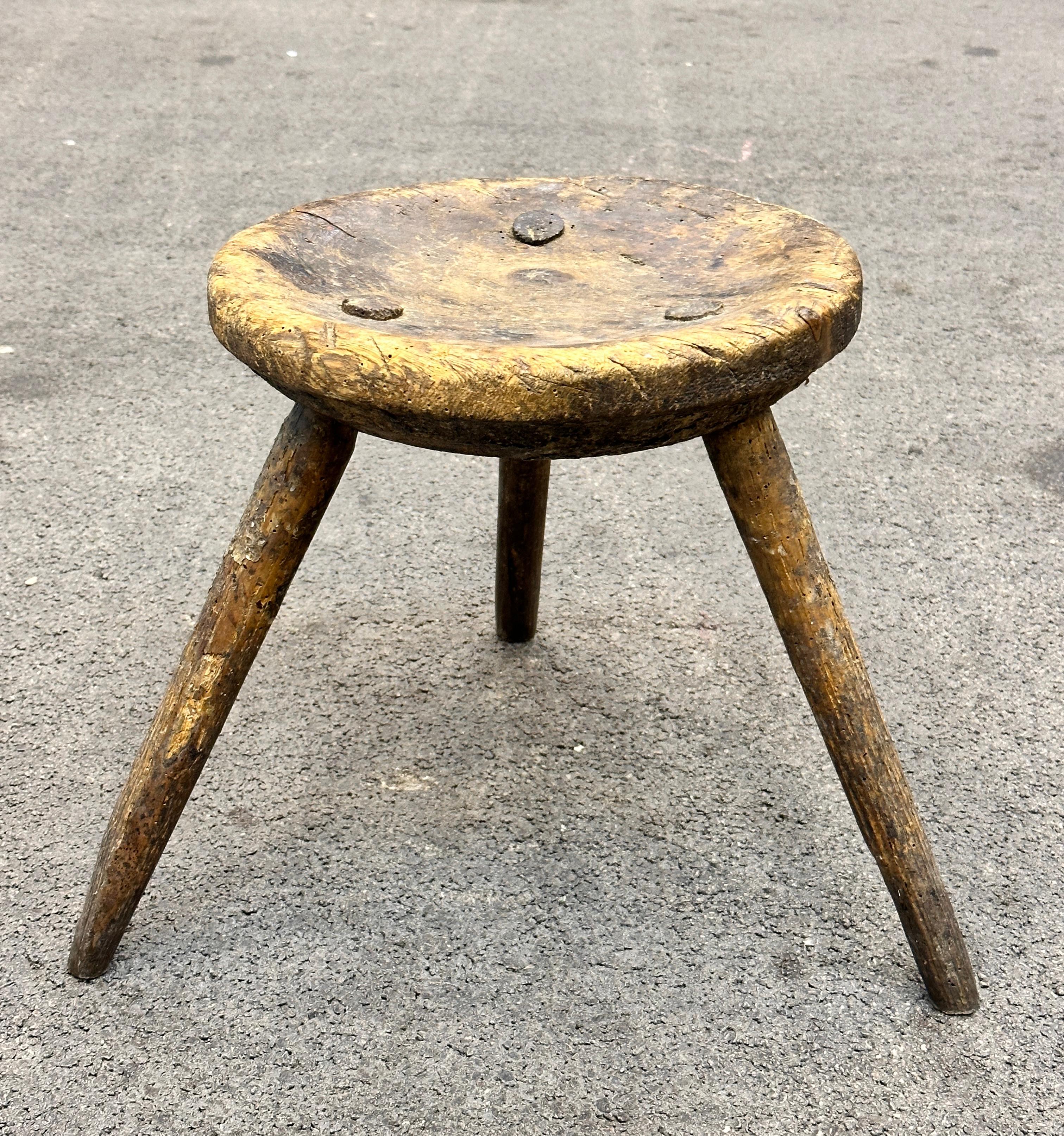 This late 19th century wabi sabi 3 leg milking stool from Austria is an excellent example of this style. The piece has a square, rustic-looking seat made of wood and is supported by three legs. The stool has a simple, understated design which is