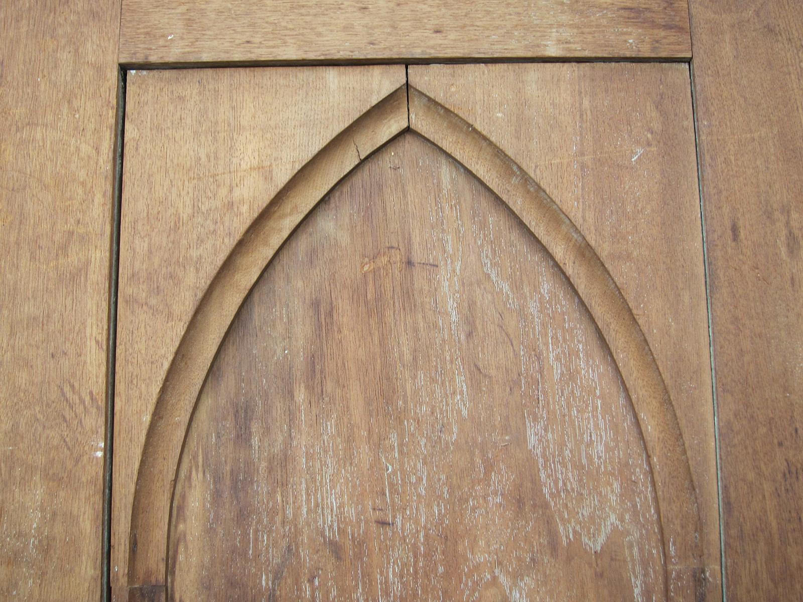 19th-20th century wood door with Gothic arch.
