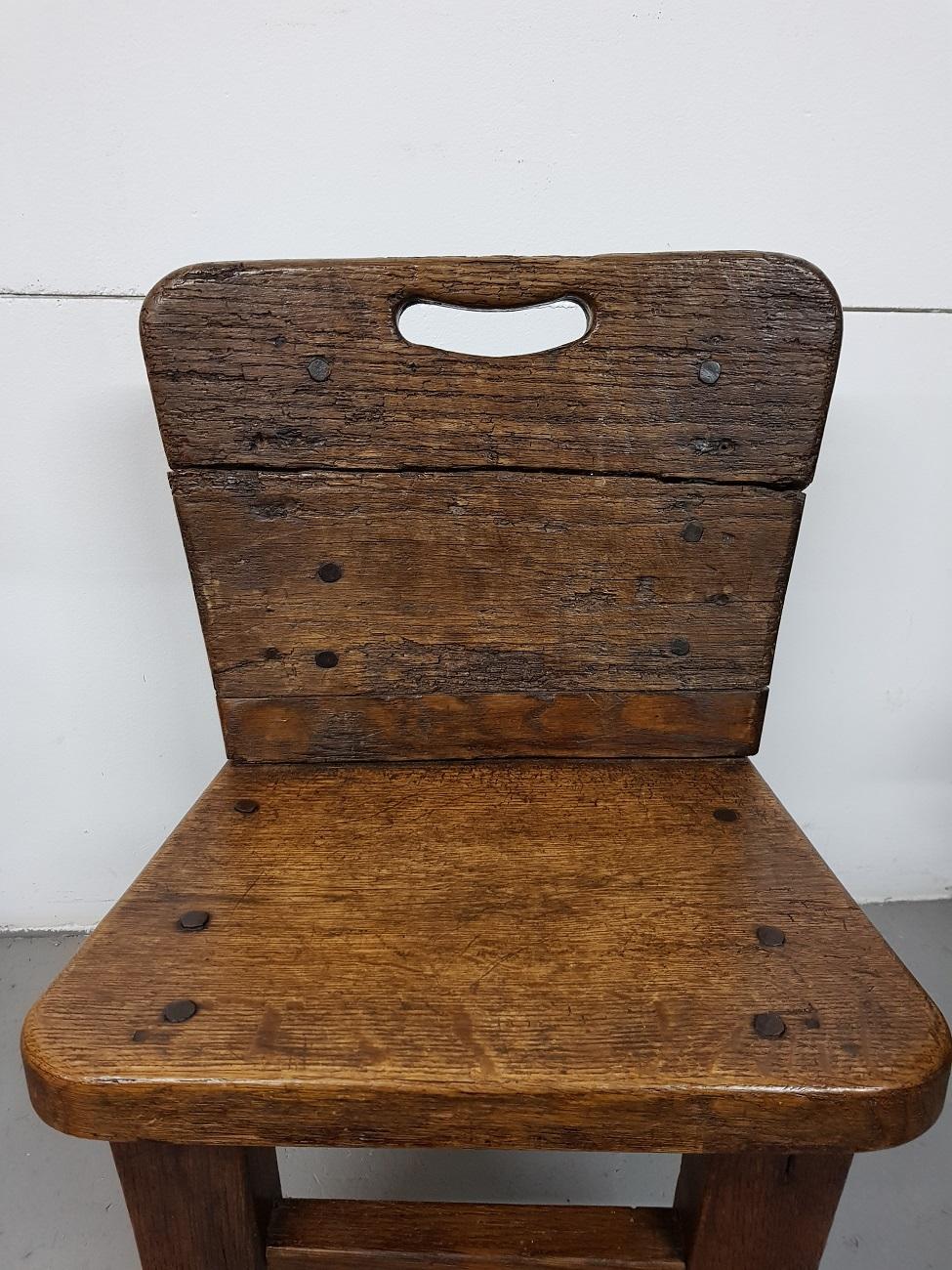 Lovely handmade old wooden rural farmers children chair made of thick planks fastened with wooden pins, 19th century or early 20th century.

The measurements are,
Depth 35.5 cm/ 13.9 inch.
Width 38.5 cm/ 15.1 inch.
Height 59 cm/ 23.2