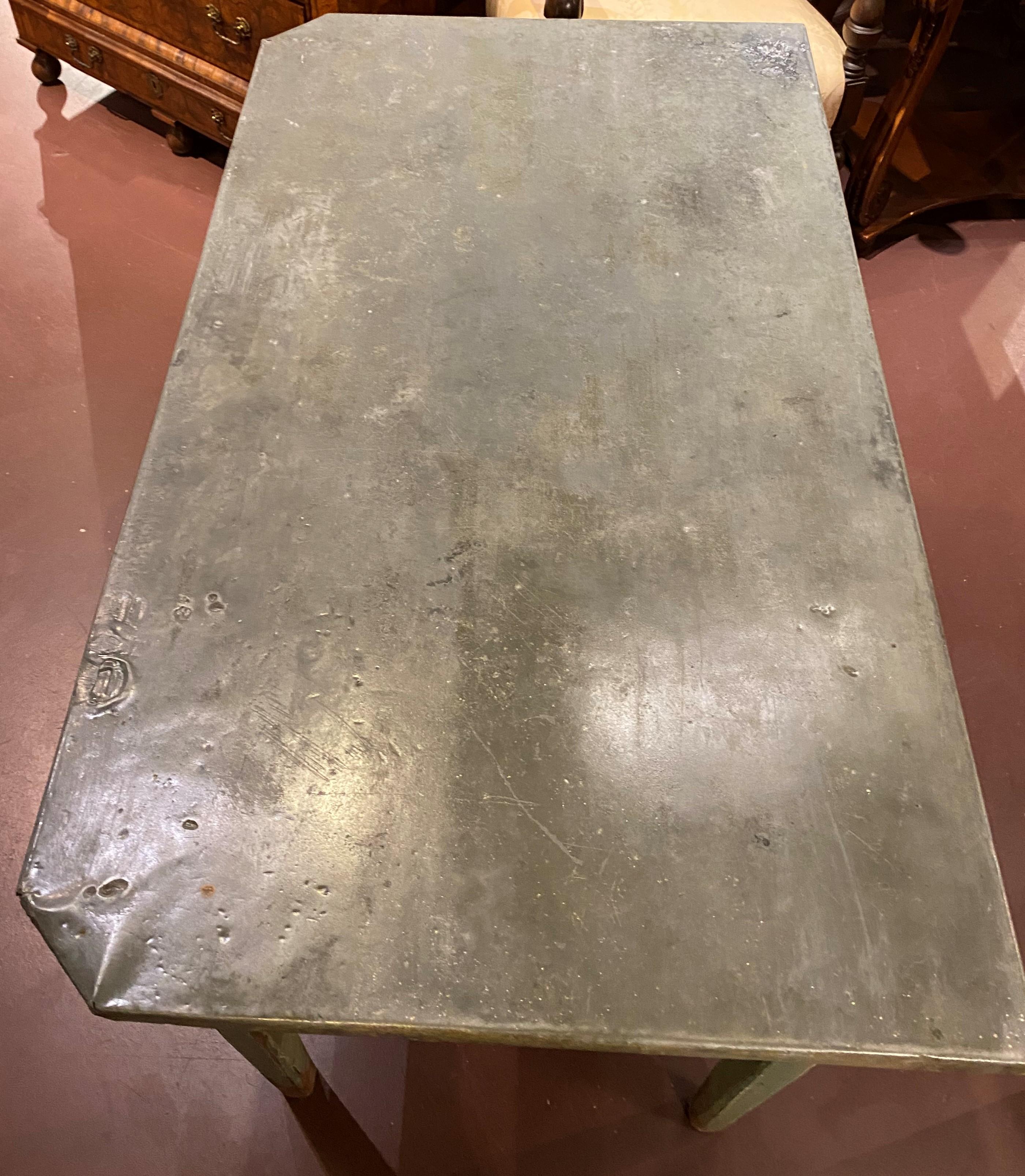 A fabulous zinc top flower or garden table in green over yellow paint with canted top corners, and a single divided frieze drawer, all supported by four tapered square legs. This table dates to the late 19th or early 20th century and is in very good