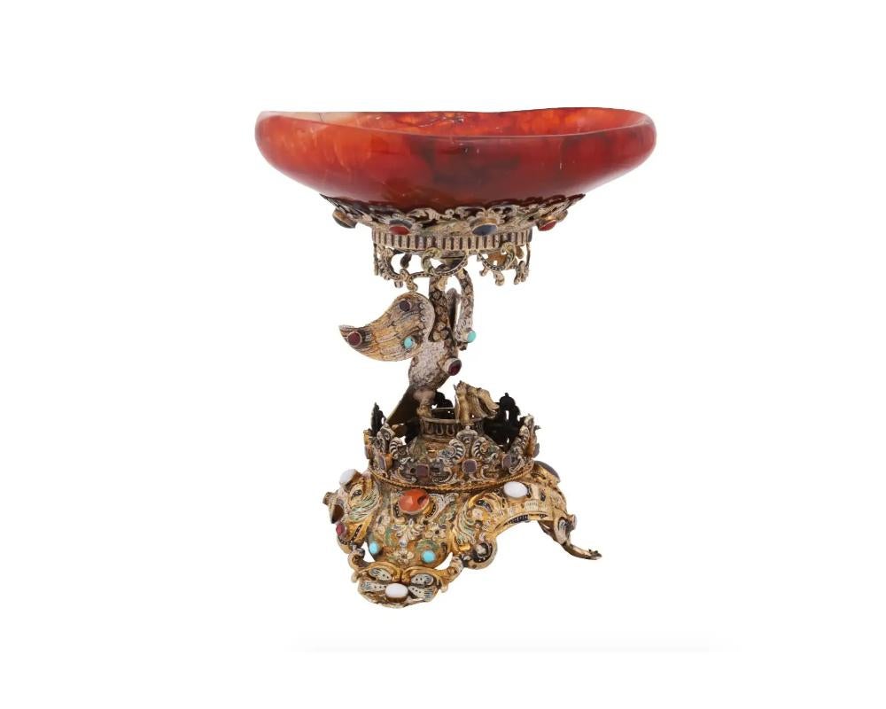 An extremely fine Antique Austrian silver gilt, carved and enameled agate tazza dated from the 19th century. Raised on a figural stem skillfully modeled as a figure of a swan set with cut garnets and turquoise cabochons. Raised on a crown mounted