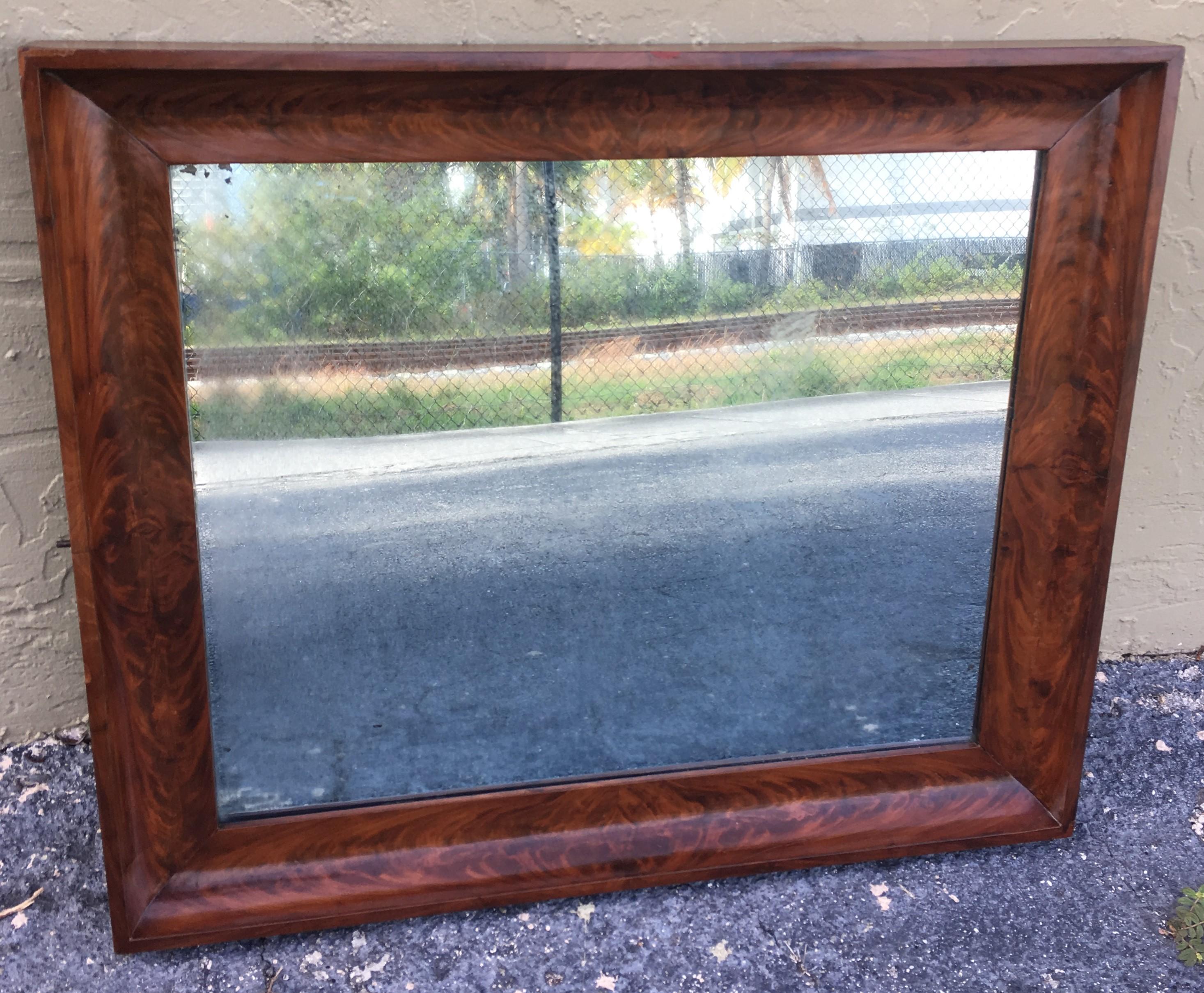 This is a beautiful antique Spanish flame mahogany wall mirror, circa 1840.

The mahogany frame is beautifullybeveled in the border 

The quality and craftsmanship of this stunning piece is absolutely superb.

In excellent condition having