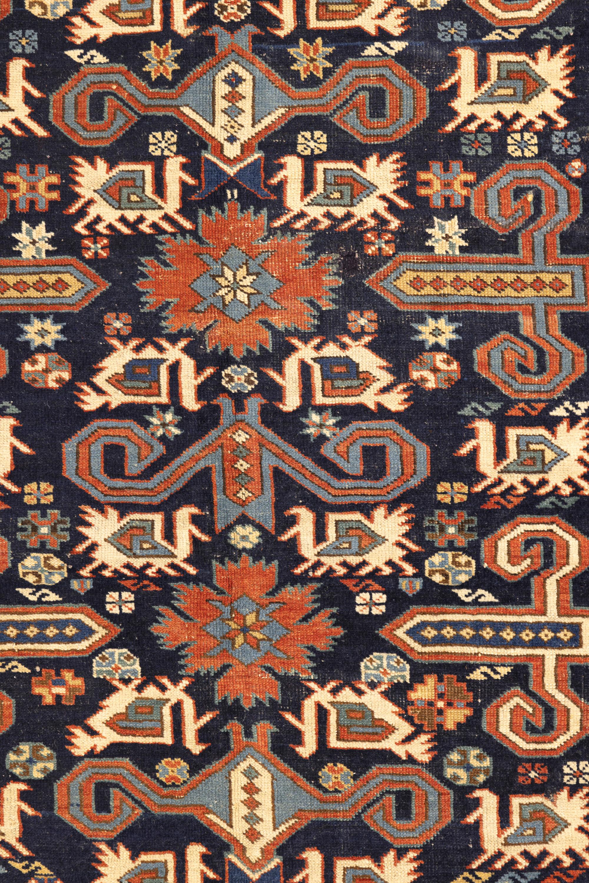 Perpedil – Kuba, Northeast Caucasus

Against a navy-blue background, this Perpedil has striking designs. Six ram’s horns (wurma) cover the central area – in blue, white and red colours. Exquisite red flowers between the horns stand out sharply and