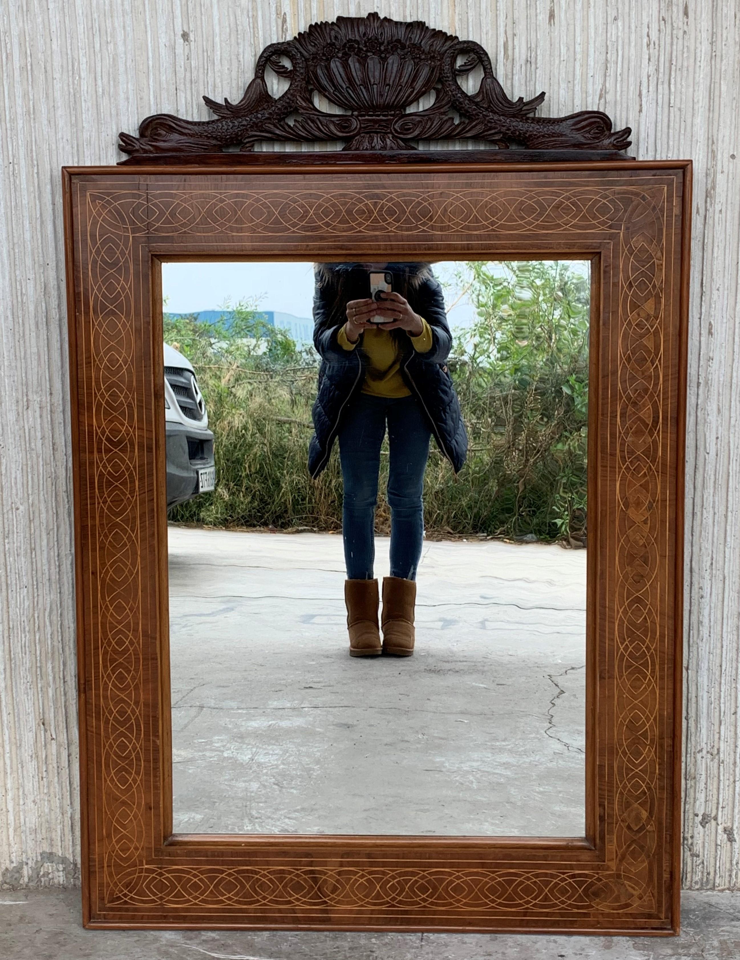 About
This is a beautiful antique Spanish flame mahogany and marquetry wall mirror, circa 1840, 19th century.

The mahogany frame is beautifully inlaid with a continuous marquetry border.

The quality and craftsmanship of this stunning piece is