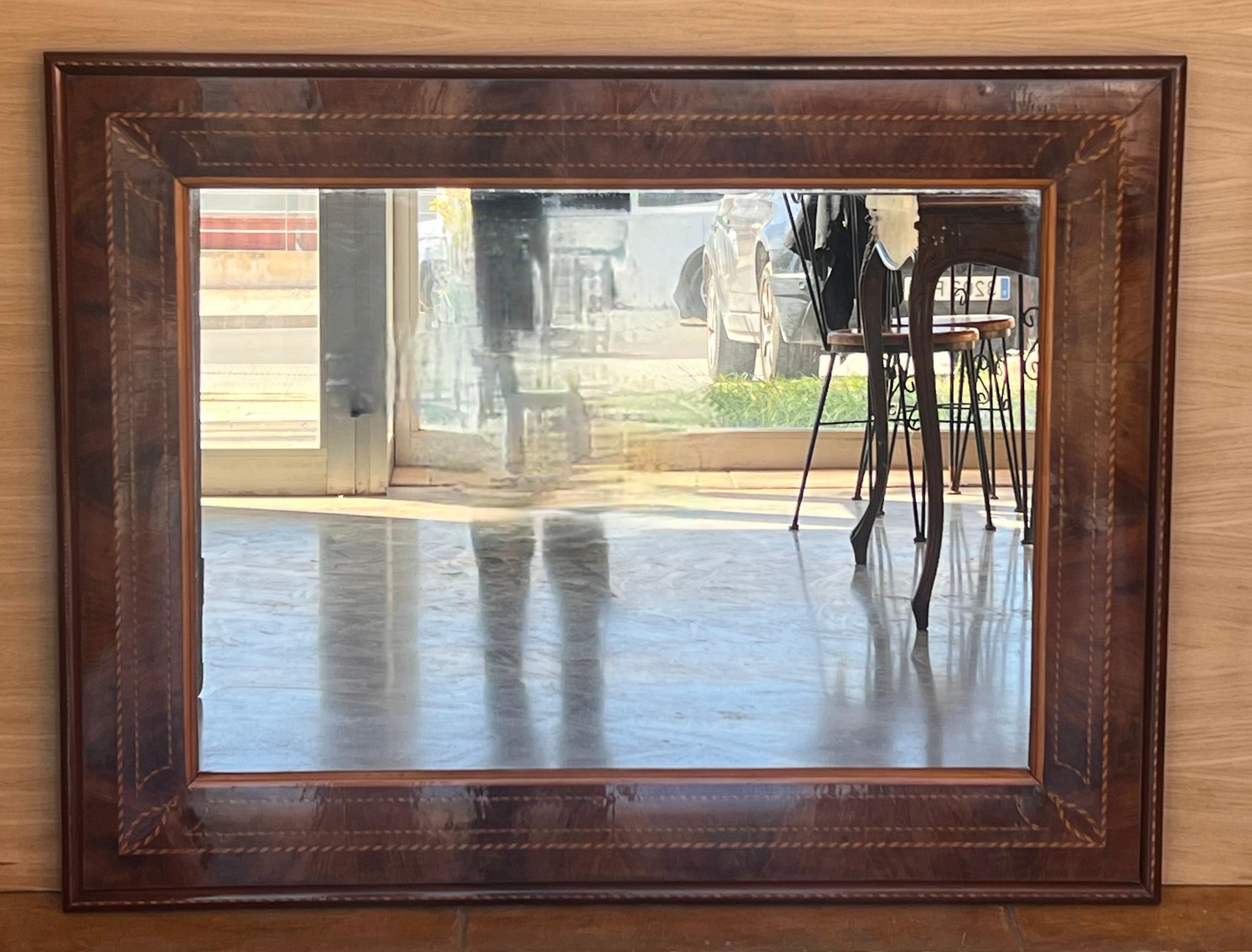 
This is a beautiful antique Spanish flame  walnut and marquetry wall mirror, circa 1840.

The walnut frame is beautifully inlaid with a continuous marquetry border.

The quality and craftsmanship of this stunning piece is absolutely superb.

In
