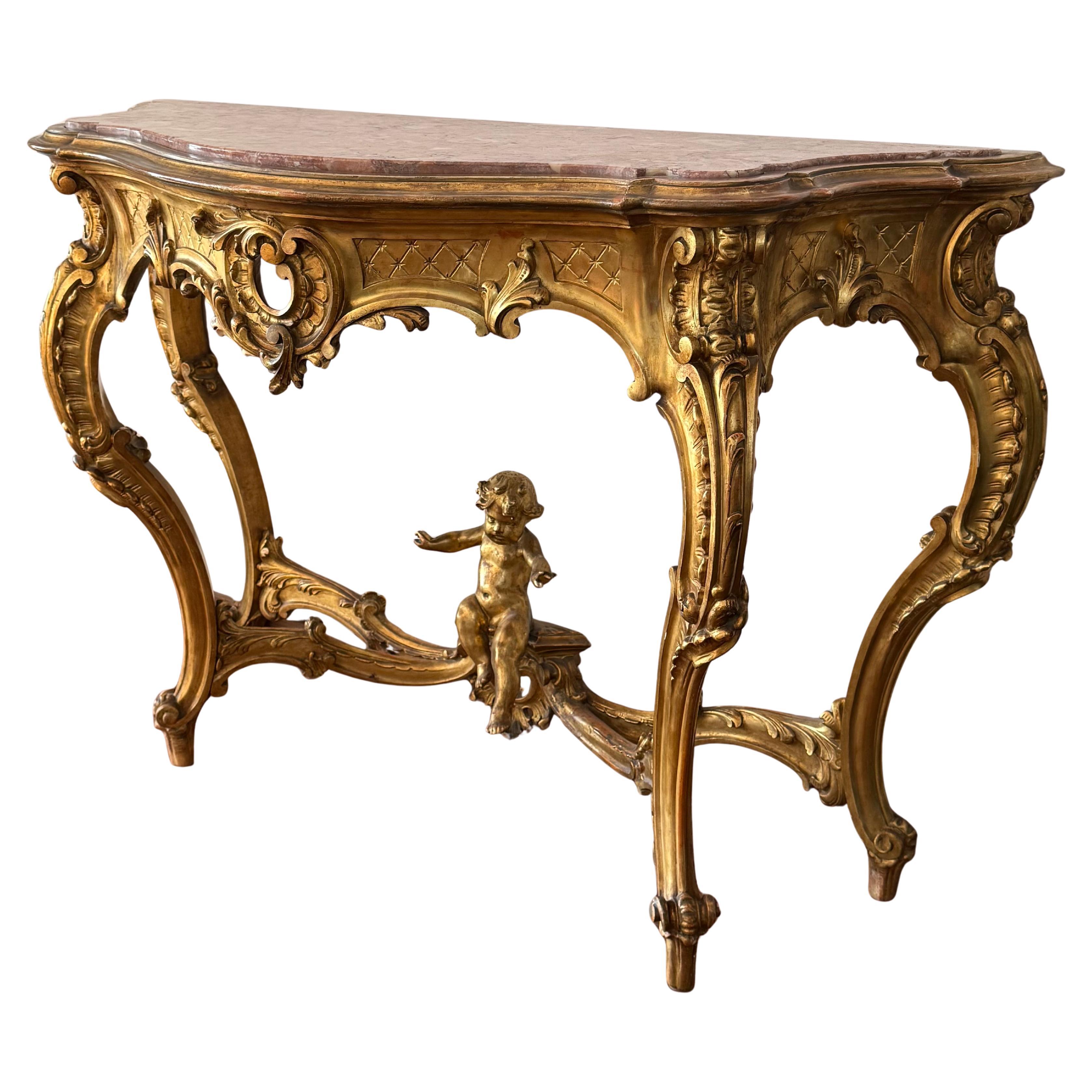 A magnificent and large scale Spanish 20th century Baroque style, ormolu and pink marble embedded console. The most impressive console is raised by elegant scrolled acanthus leaf feet below the powerful scrolled legs with richly carved flowers and
