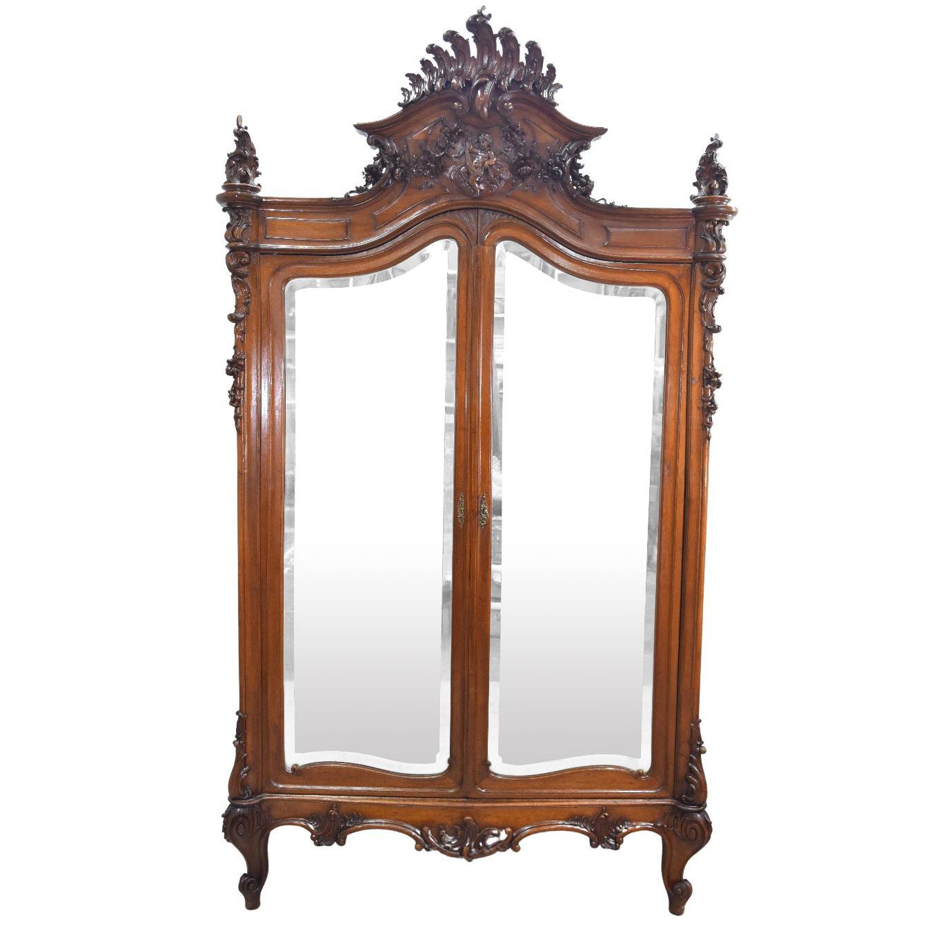 19th Baroque Louis XV Rococo style mirror cabinet in walnut with putti with 2 richly carved doors dimension height 265 cm for a width of 165 cm and depth of 55 cm. Part of a set including a wardrobe a bed a pair bedside tables and a dressing table.