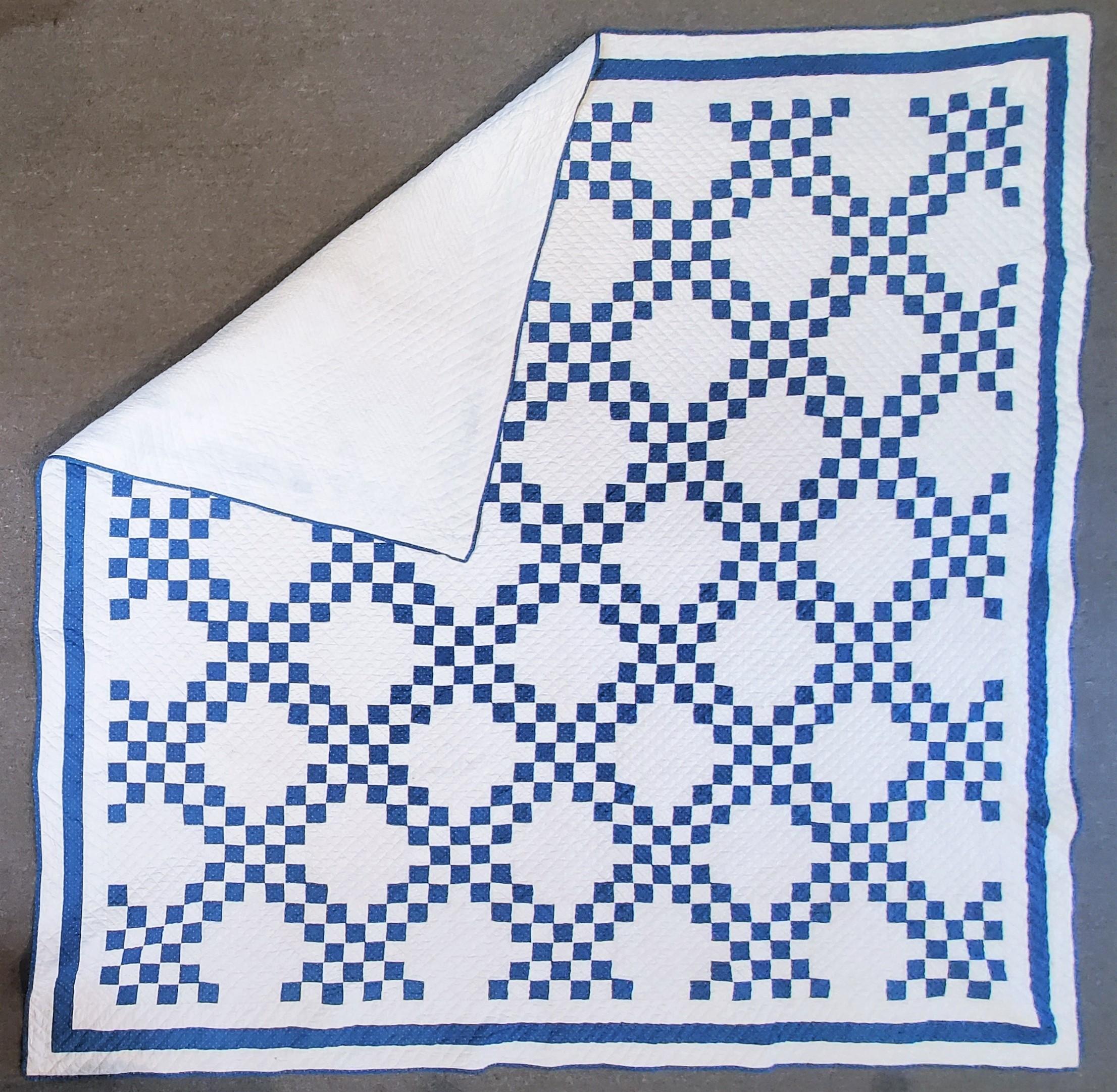 This fine blue & white calico fabric Irish chain quilt is a large size quilt and in pristine condition. This quilt could go on a full size or queen size bed.