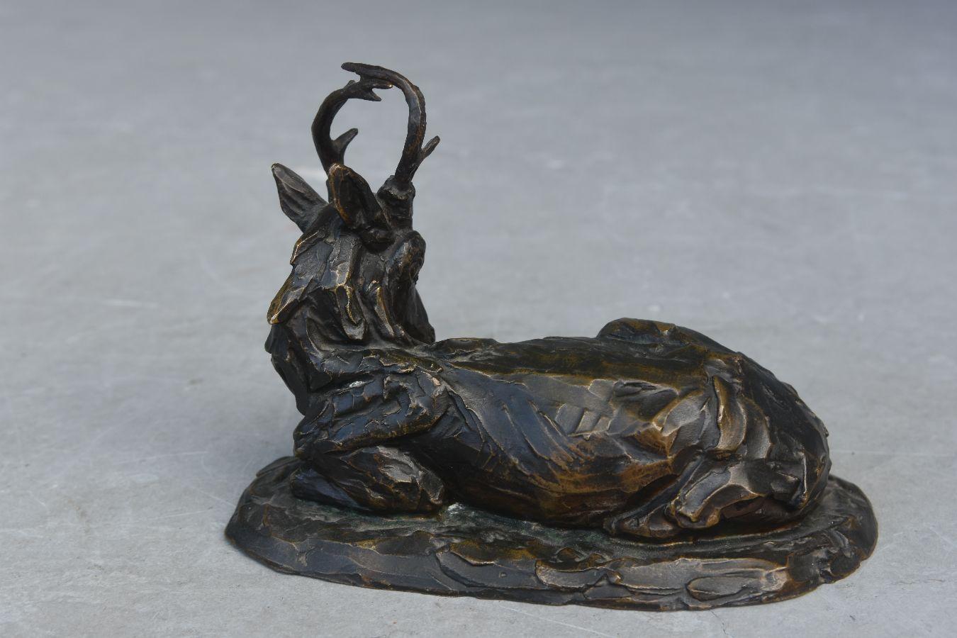 resting deer statue