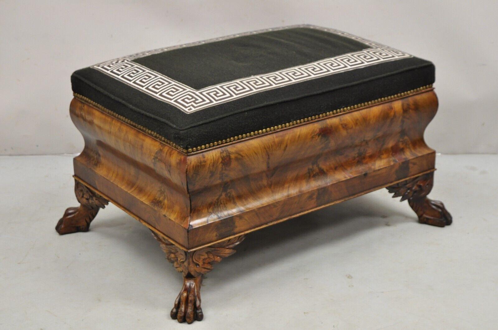 19th C. American Empire Carved Winged Paw Foot Mahogany Large Box Stool Ottoman. Item featured is a very rare model, shapely raised box form, beautiful crotch mahogany veneer, black wool upholstery with Greek key trim, nice larger size ottoman,