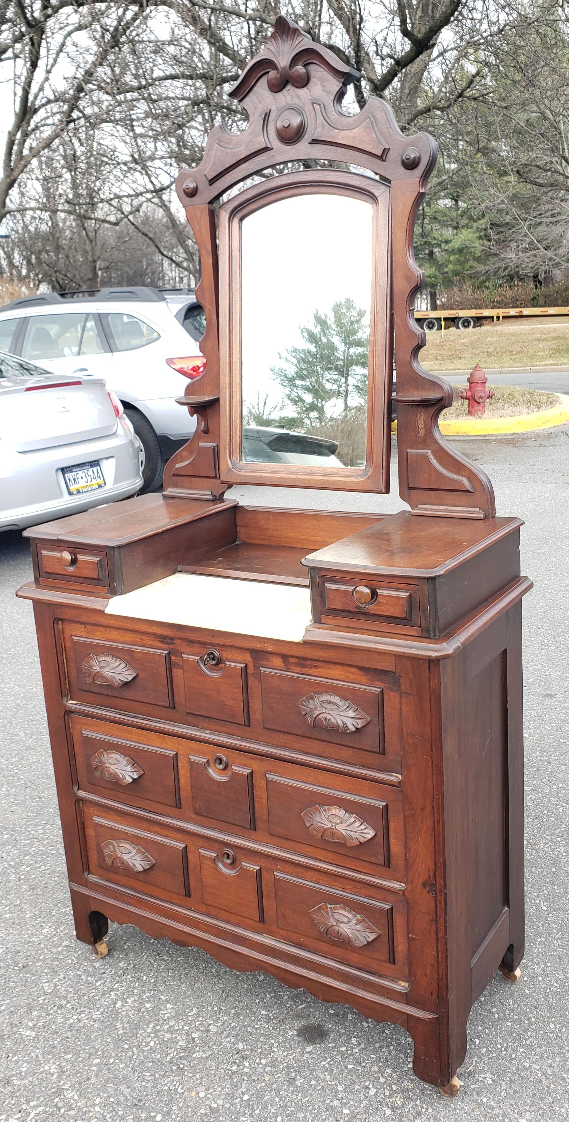 19th Century. American Empire Eastlake Mahogany Dresser with Marble Top Inset and edwardian style Mirror on wheel. 3 large drawers and 2 small drawers. Measures 38.75W x 17.5
