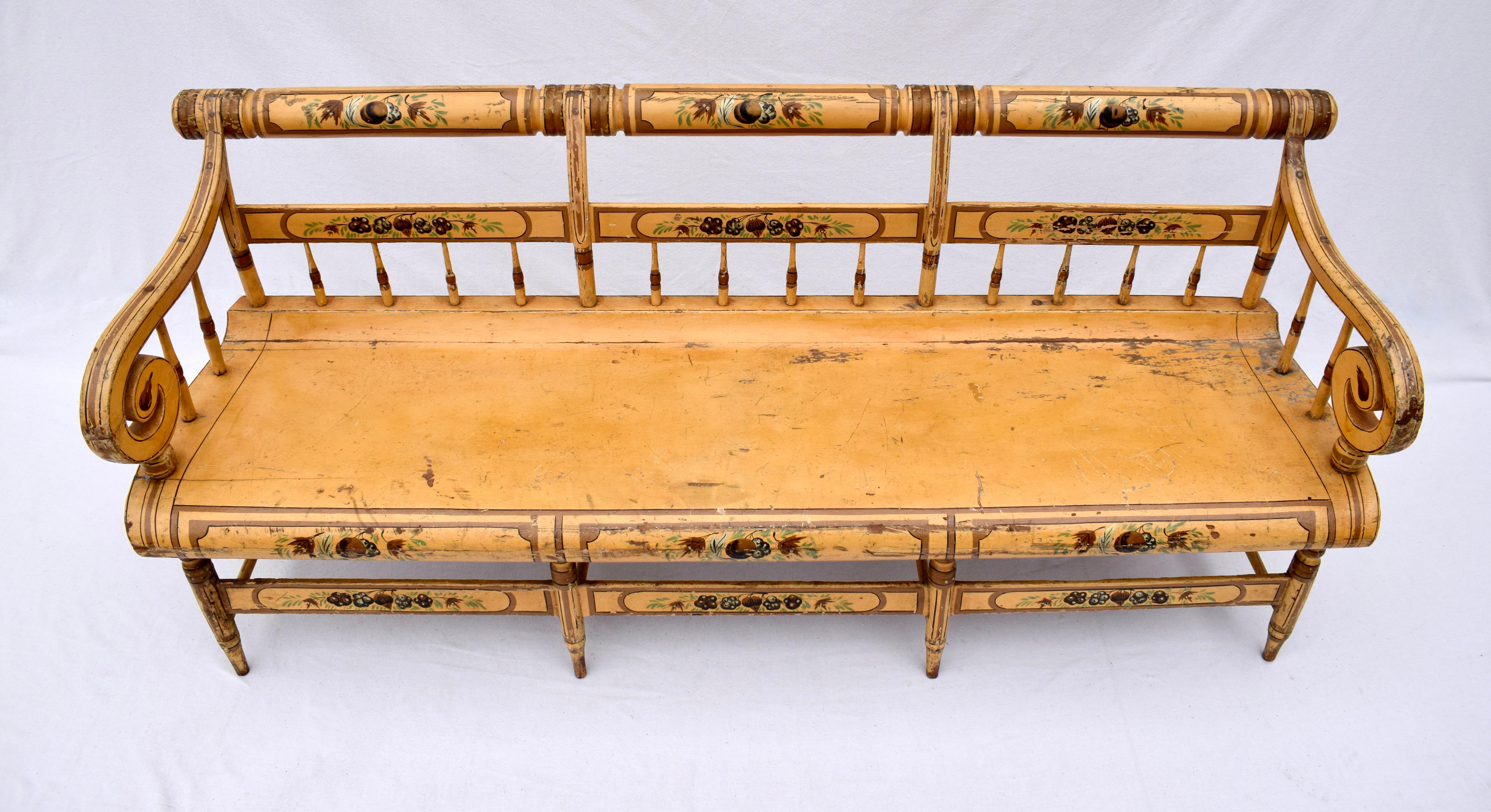 An Antique American Federal hand painted floral & fruits solid wood bench with rolled crest rail & scroll arms; most likely originating in Baltimore mid 19th c.  Scarcely seen in this unique style the bench is of heirloom quality & ready for use. 