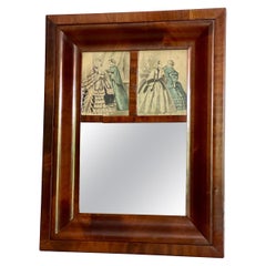 A.I.C., A.I.C. Miroir de forme ogivale en acajou flammé avec gravures de mode françaises d'époque