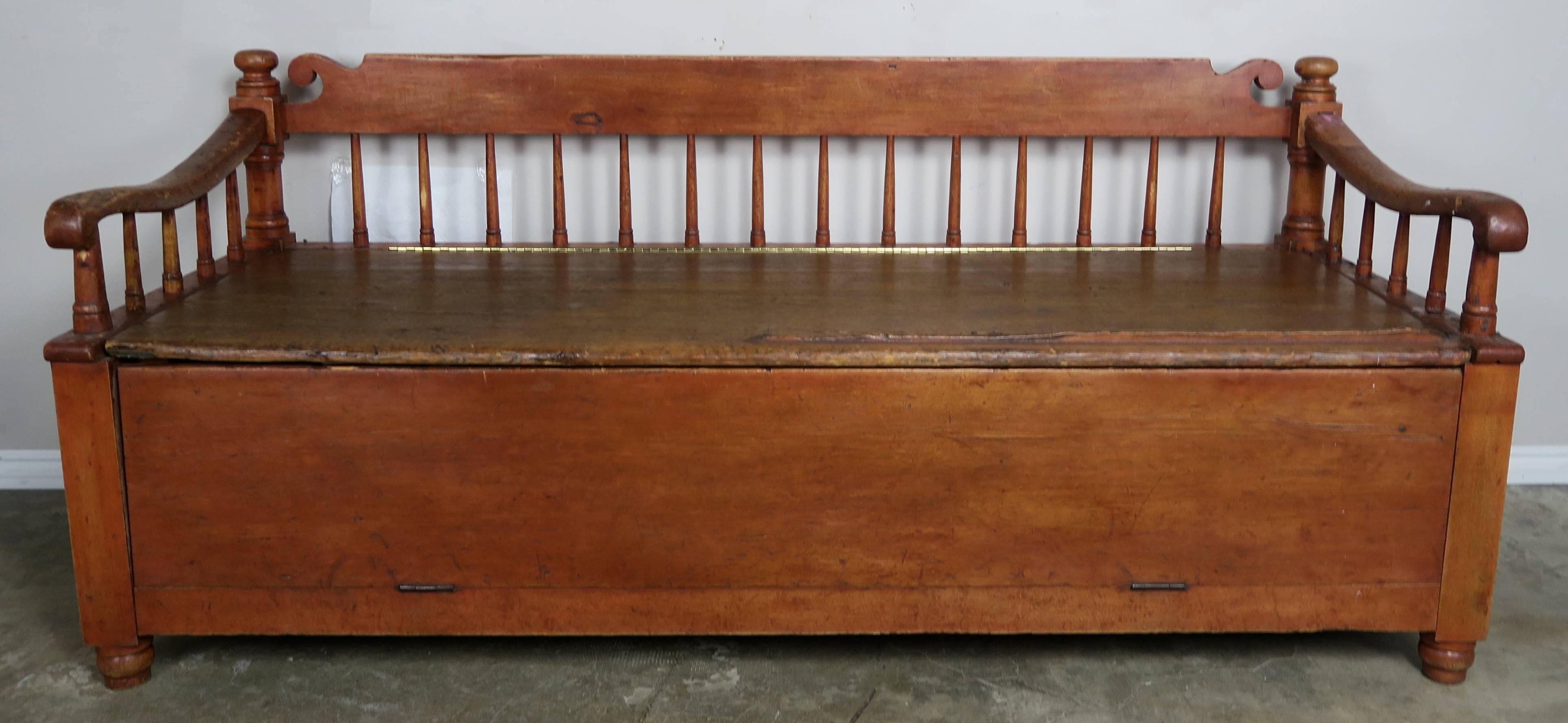 19th century American painted storage bench with upholstered down filled loose cushion. Spindle back and sides.
Measures: Seat height 25