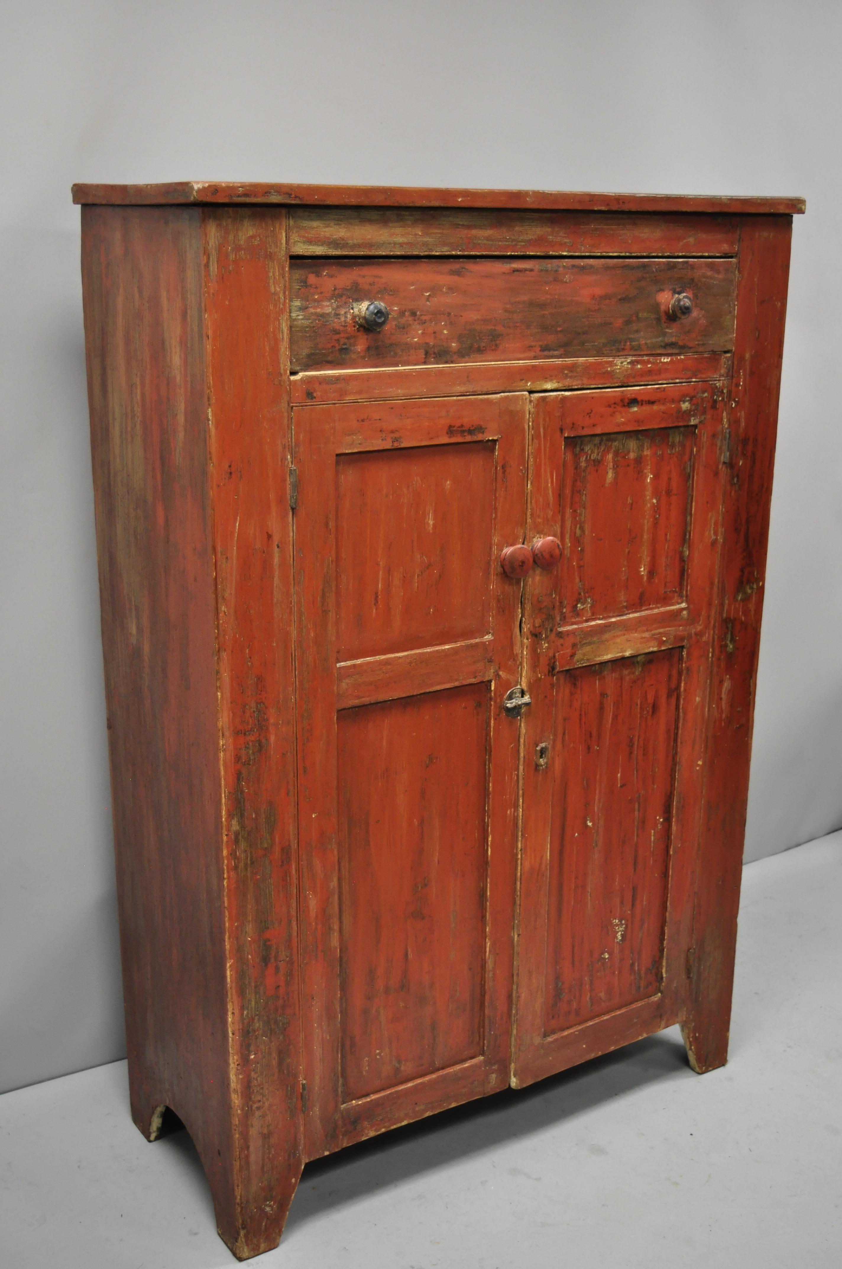 Antique 19th century American primitive red distress painted cupboard hutch pie safe cabinet. Item features remarkable distress painted red finish, wonderful patina, solid wood construction, 2 swing doors, 1 dovetailed drawer, 4 wooden shelves, very