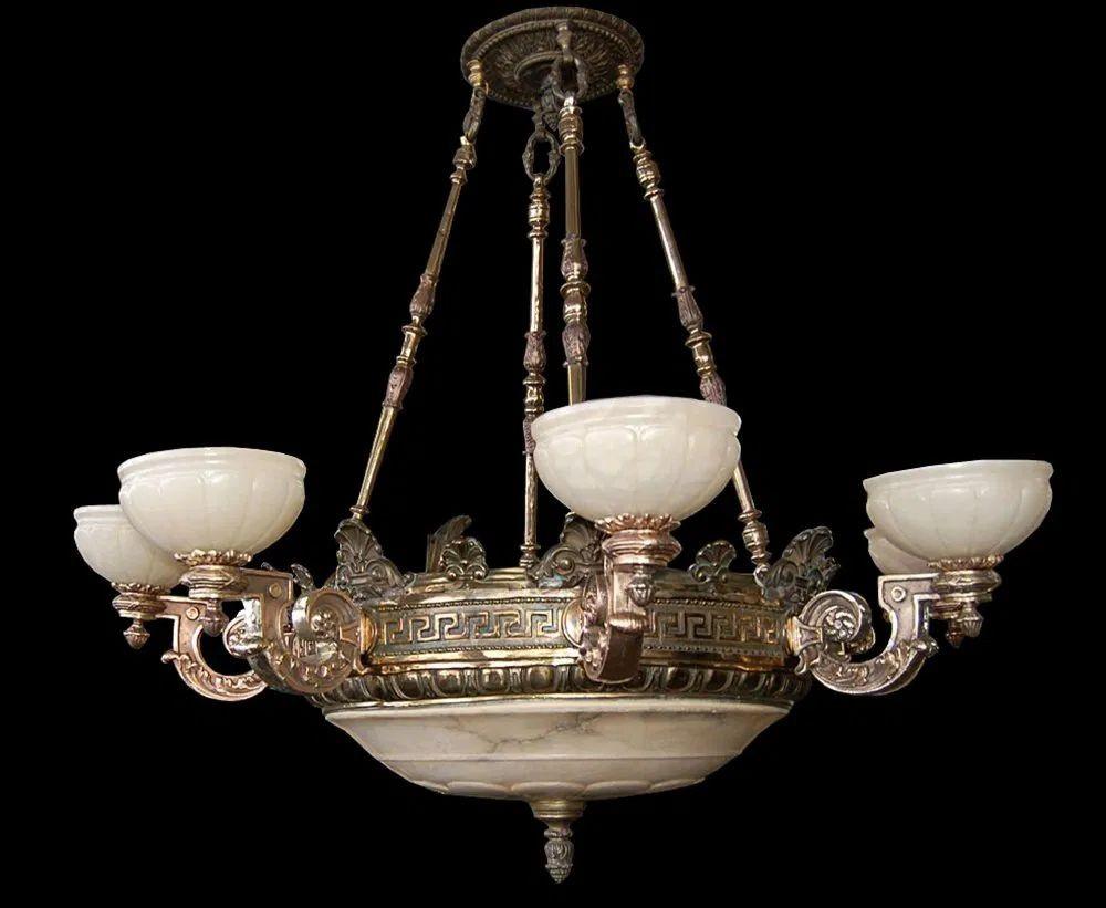 with an elegant eight-arm design. This beautifully detailed fixture embodies the grandeur of the Victorian era, featuring finely cast classical motifs. Each of the eight gracefully curved arms supports an alabaster shade, which emits a soft, warm