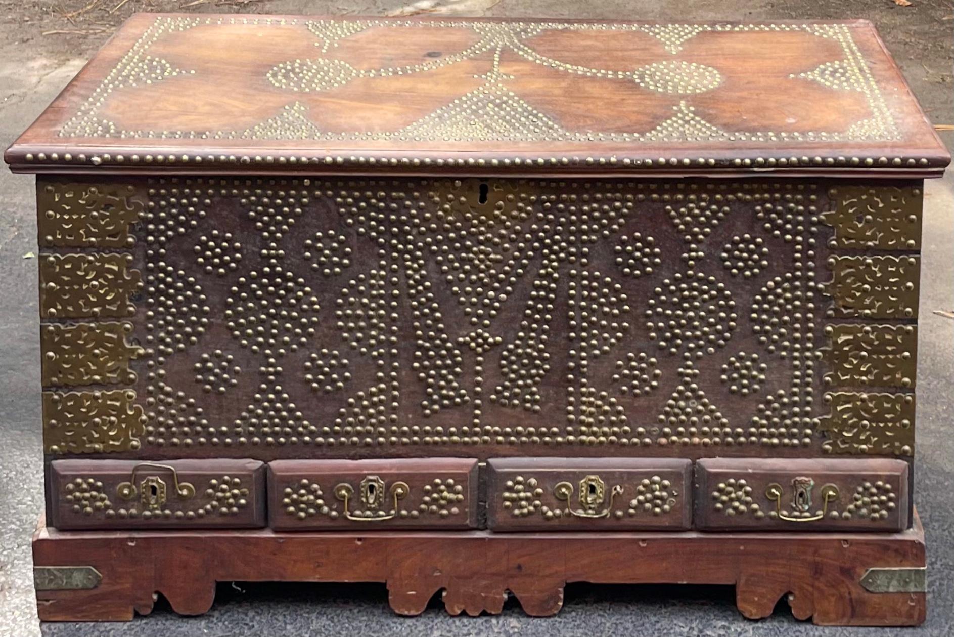 This is an exceptional Anglo-Indian brass clad hand forged trunk. It is carved Padauk wood with an elaborate brass studded / nailhead design on the front and top. Note the hinges and handles! A great statement piece!

My shipping is only for the