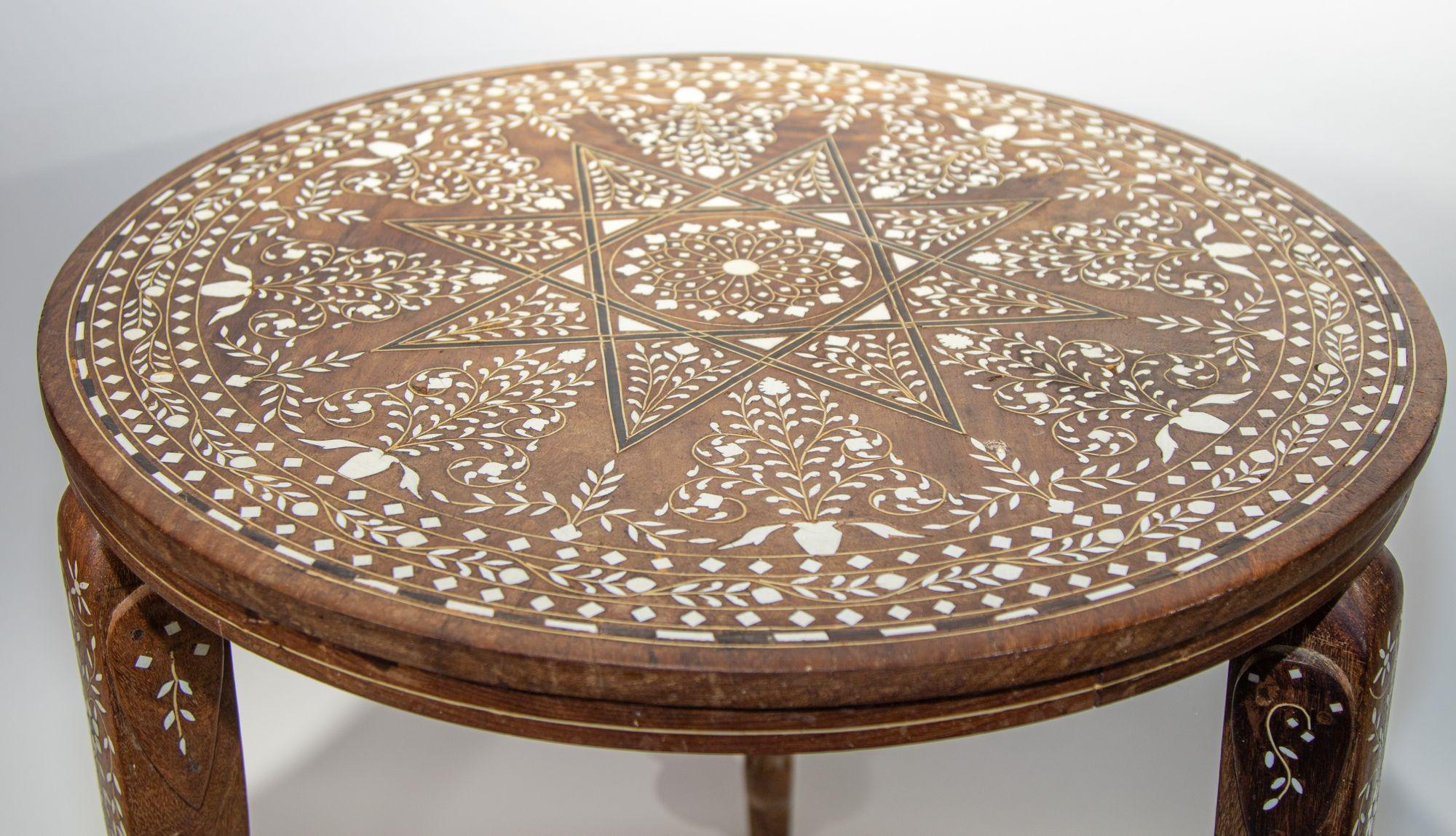 Antique 19th c. Anglo Indian Mughal teak inlaid side table.
Fine and elegant Moorish round side table hand carved with bone inlaid elaborate Moorish geometric design.
With elephant inlaid bone figurative detail on the 3 supporting legs.
Size: 20