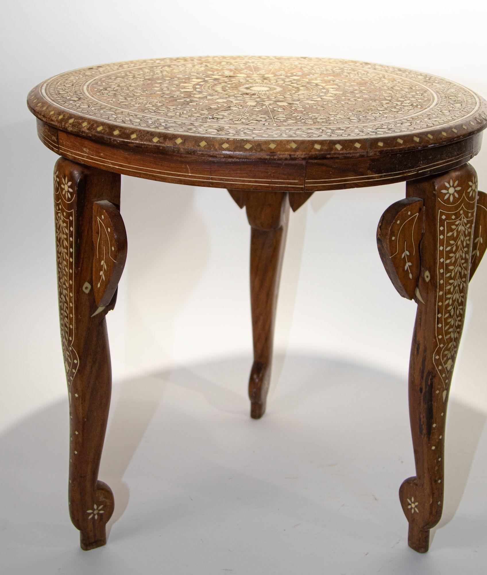 Antique 19th c. Anglo Indian Mughal teak inlaid side table.
Fine and elegant Moorish round side table hand carved with bone inlaid elaborate Moorish geometric design.
With elephant inlaid bone figurative detail on the 3 supporting legs.
Size: 18