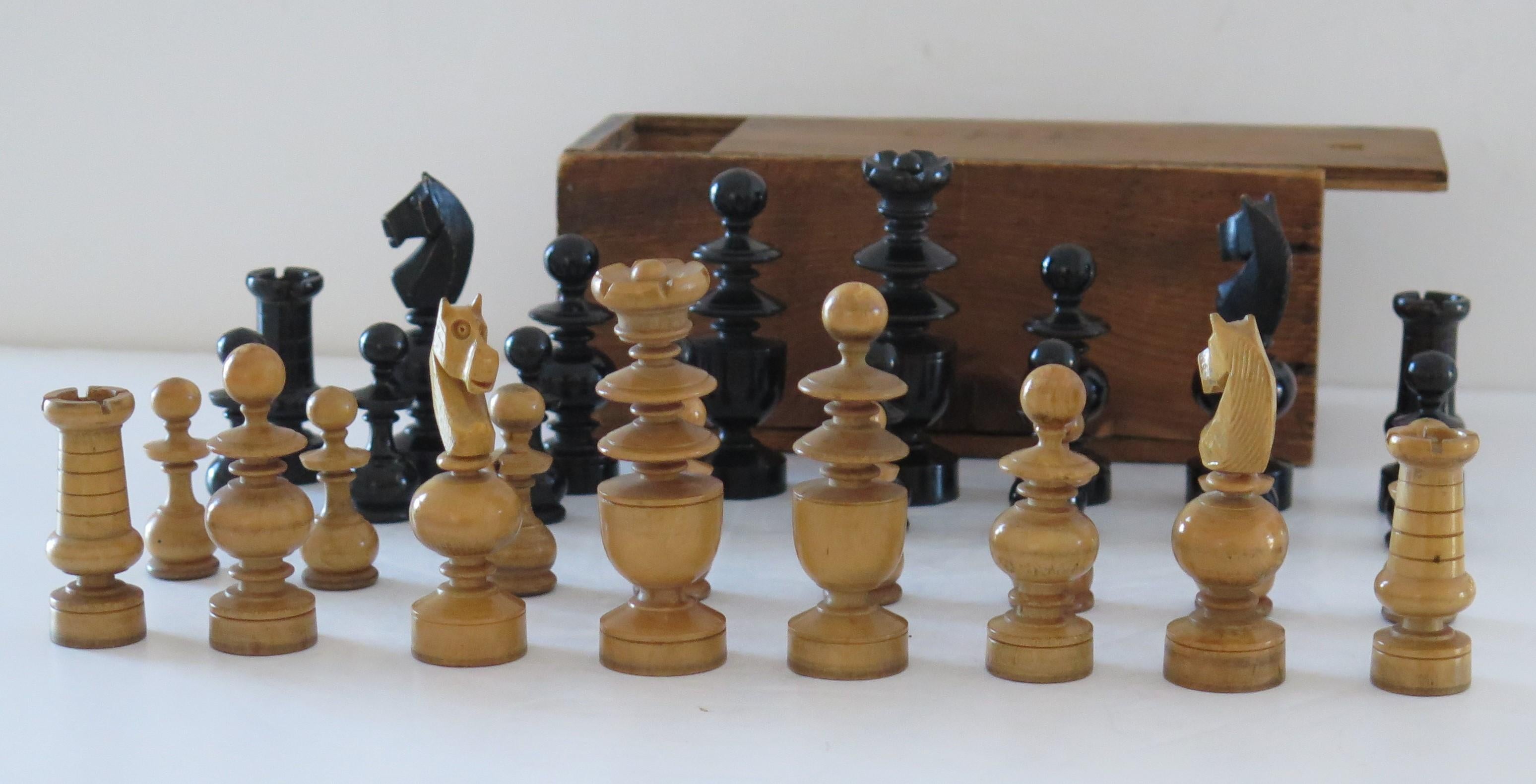 This is a very good and complete handmade, hardwood chess set game of 32 pieces in a handmade pine box with a sliding lid, which we date to the turn of the 19th Century, Circa 1900.

The chess set is complete with 32 handmade and turned hardwood