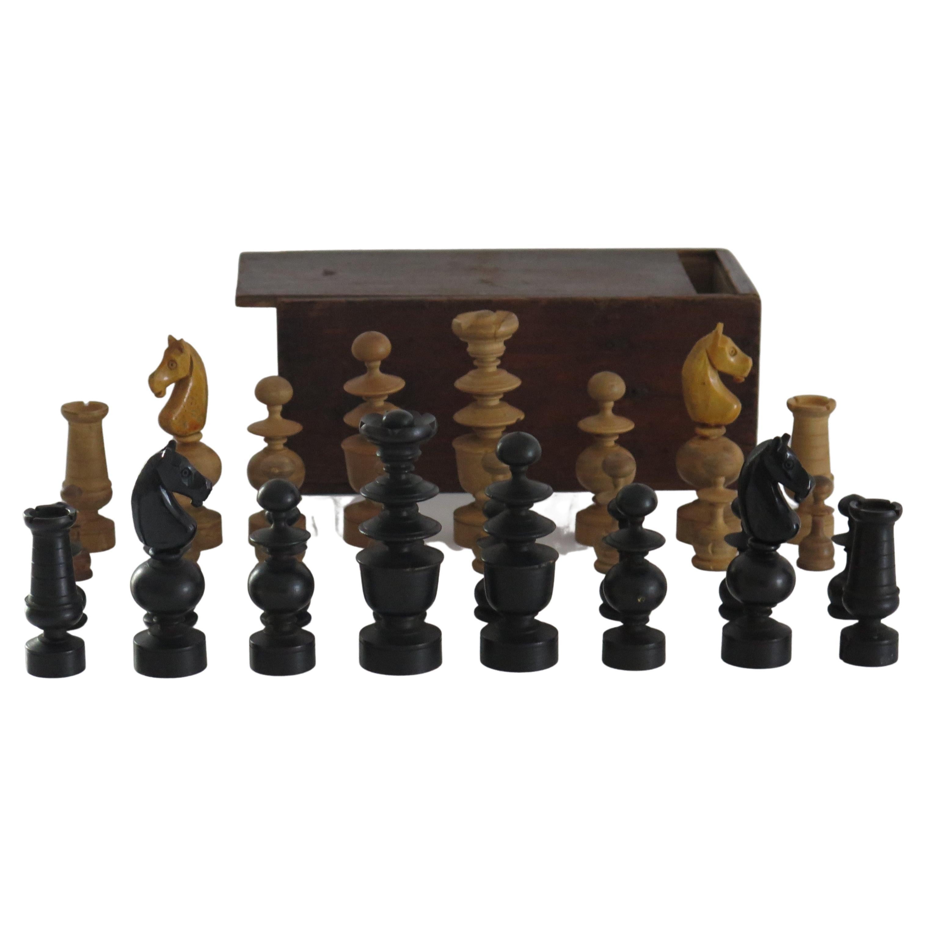 This is a very good and complete handmade, hardwood chess set game of 32 pieces in a handmade pine box with a sliding lid, which we date to the turn of the 19th Century, Circa 1900.

The chess set is complete with 32 handmade and turned hardwood