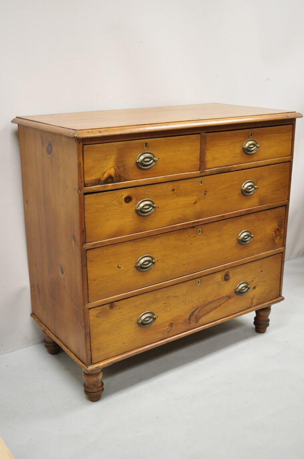 19th C. Antique Pine Wood 5 Drawer Primitive Colonial Chest Of Drawers Dresser. Item features turn carved bun feet, solid wood construction, beautiful wood grain, no key, but unlocked, 5 dovetailed drawers, very nice antique item, quality American