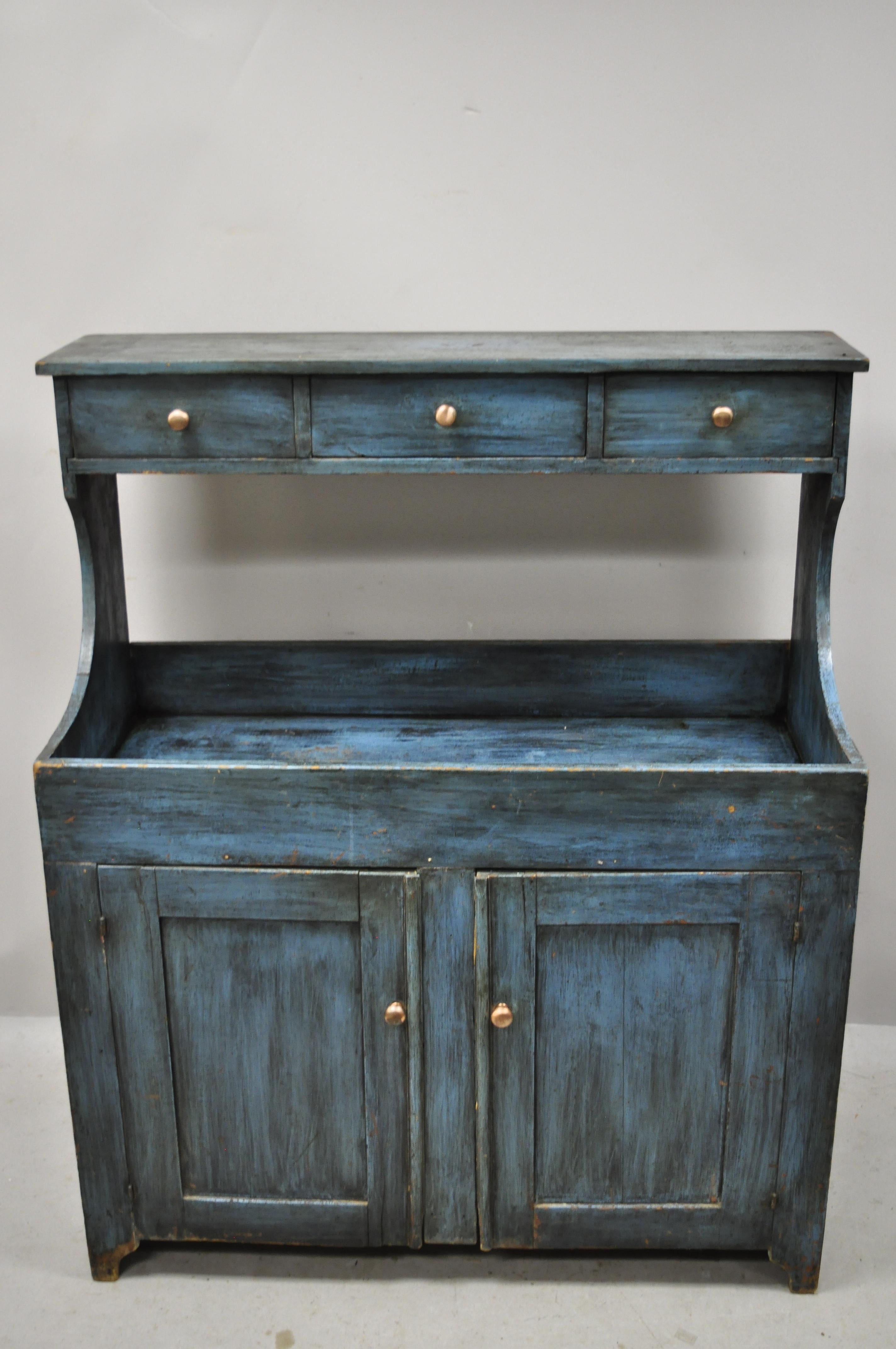 19th century antique primitive country blue distress painted stepback hutch cupboard cabinet. Item features 3 pin and cove constructed drawers, 2 swing doors, very nice antique item, quality American craftsmanship, great style and form.