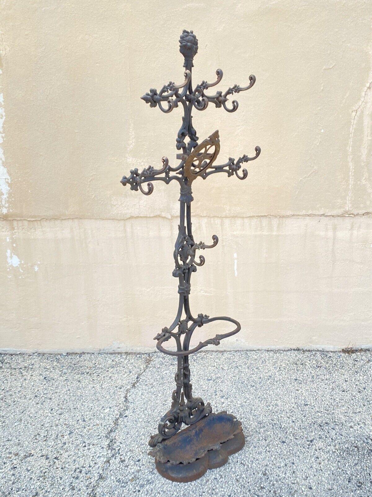 19th Century Antique Victorian Cast Iron Rococo Hall Tree Coat Hook Umbrella Stand. Item features multiple ornate hooks, removable cast iron drip pan, frame for central mirror (glass missing, cast iron construction, very nice antique item, quality