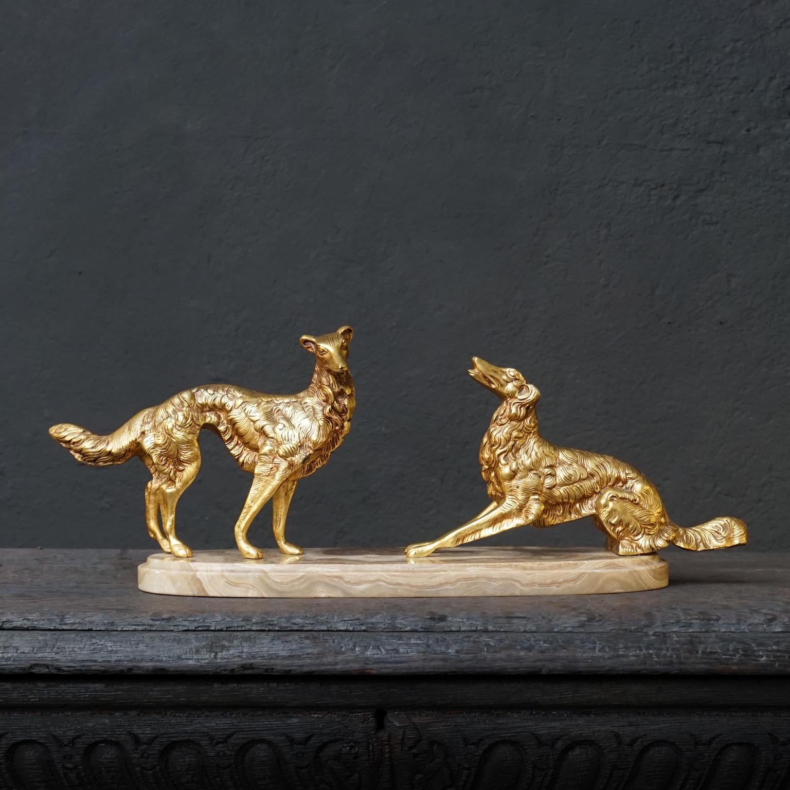 An antique French brass patinated Art Deco set of Borzoi dogs on a cream or 'cafe au lait' marble base.

Very pretty and decorative, its weight (6 kilo's) would make it an excellent paperweight.

The Borzoi Barzoi or Borzaya, also called the