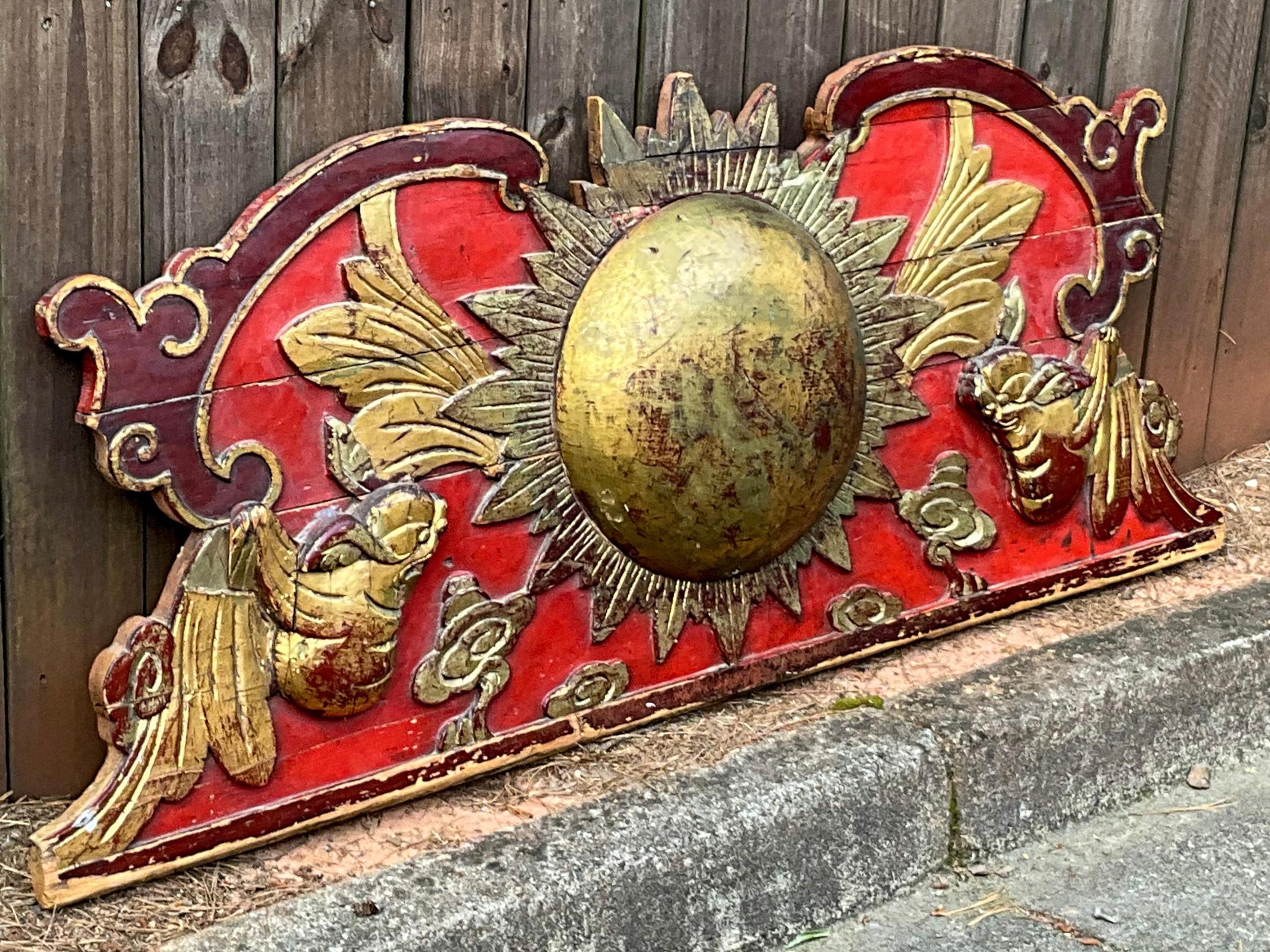 I love this piece! This is a large scale 19th century carved wood Chinese fragment in vivid reds and golds with a dramatic sunburst focal point. It has almost a Rococo Italianate feel to it. This architectural element would look fantastic over an