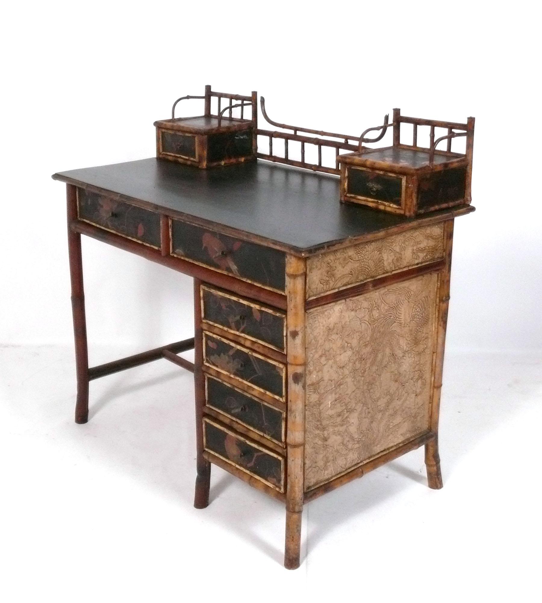 Chinoiserie Lacquered Bamboo Desk, France, circa late 19th Century. Beautiful hand painted aesthetic movement decoration. It is a versatile size and can be used as a desk, writing table, vanity, or bar. The height to the desk top is 29