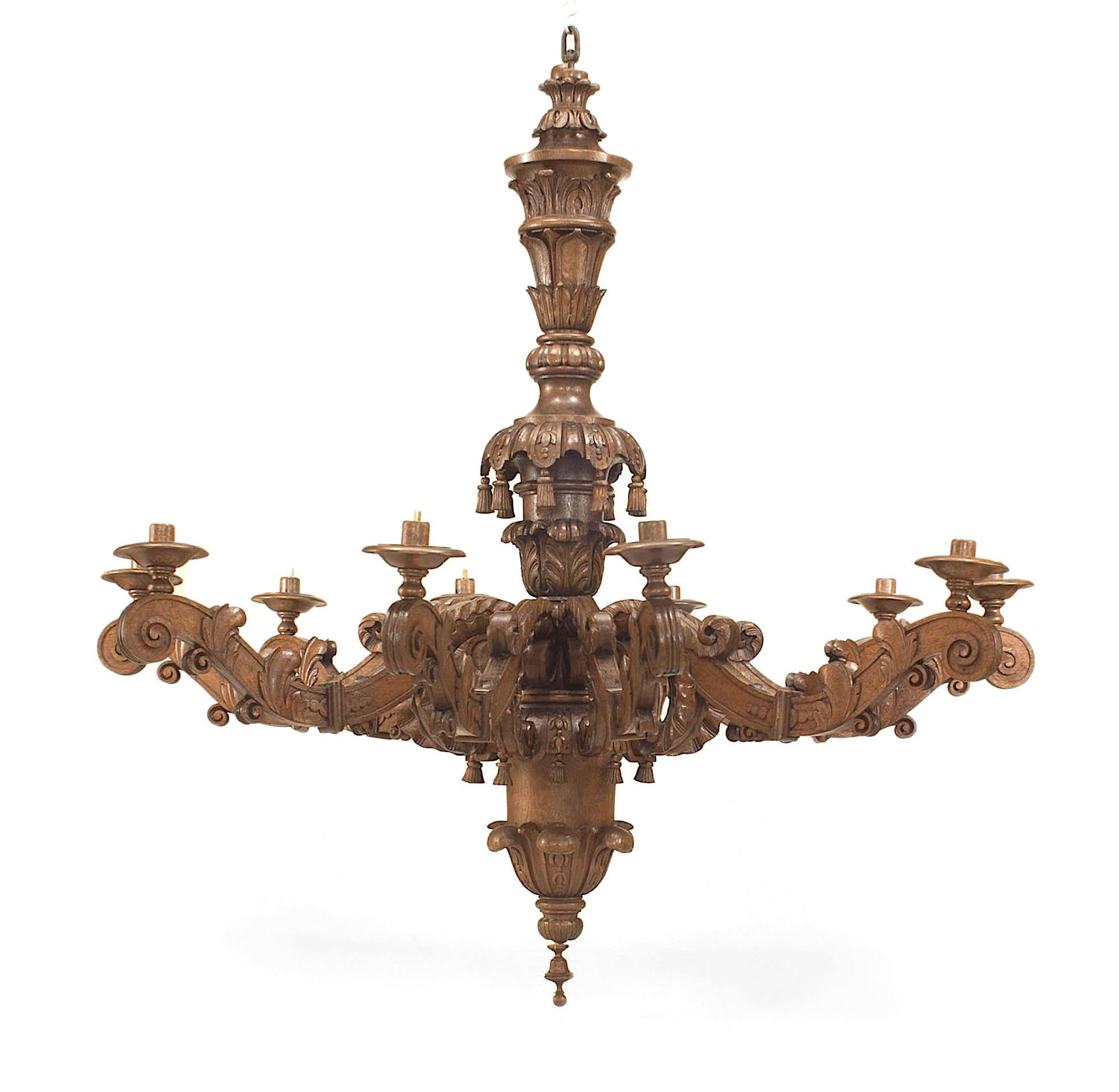2 Italian Rococo style (19th Century) large carved oak chandeliers with 10 scroll arms emanating from a carved center post with carved tassel trim. (PRICED EACH)
