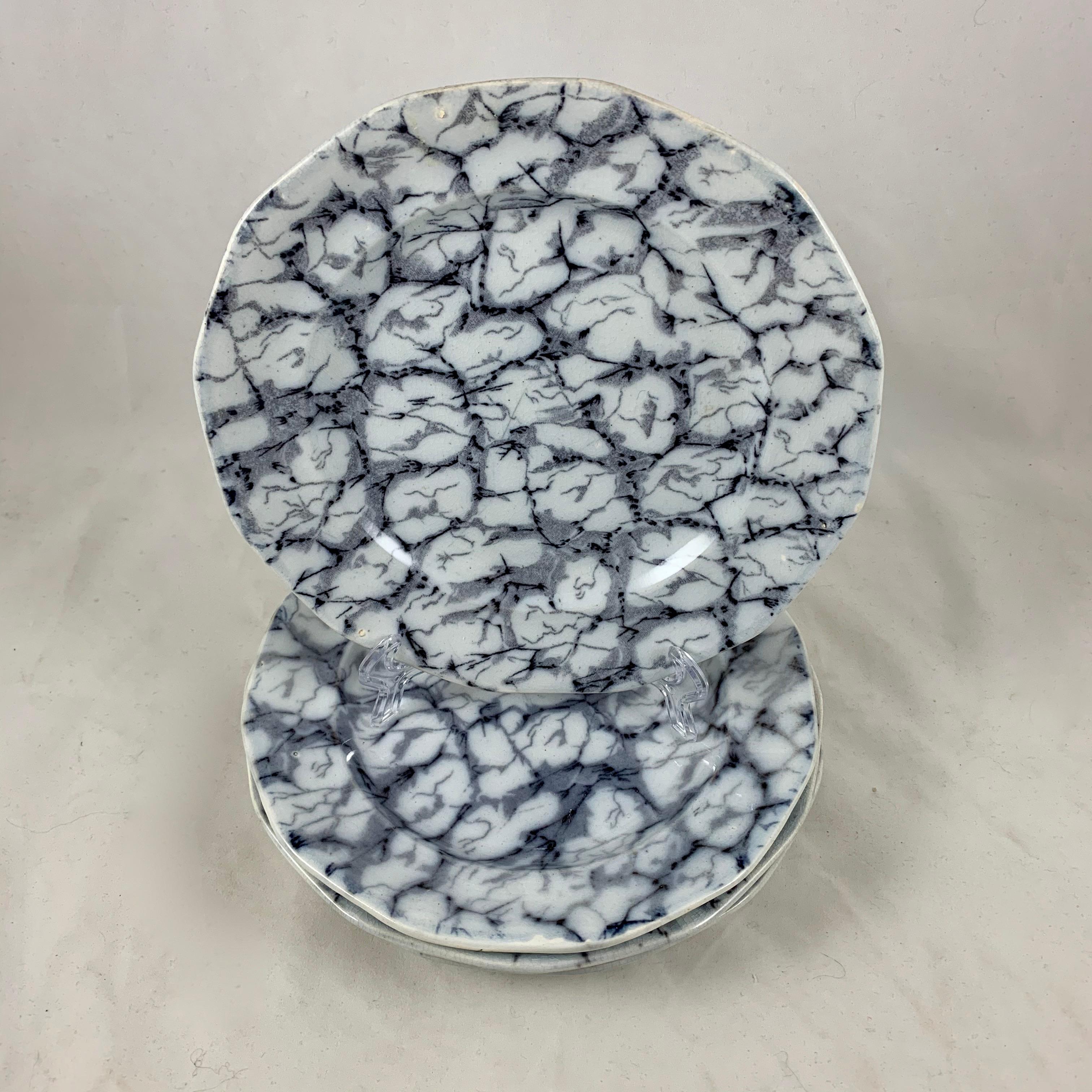 A set of four early 19th Century English Ironstone, twelve sided plates in a ‘Marble’ pattern, sometimes called ‘Cracked Ice.’ A tissue printed sheet pattern, applied under the glaze, in shades of black and gray on a white stoneware body showing